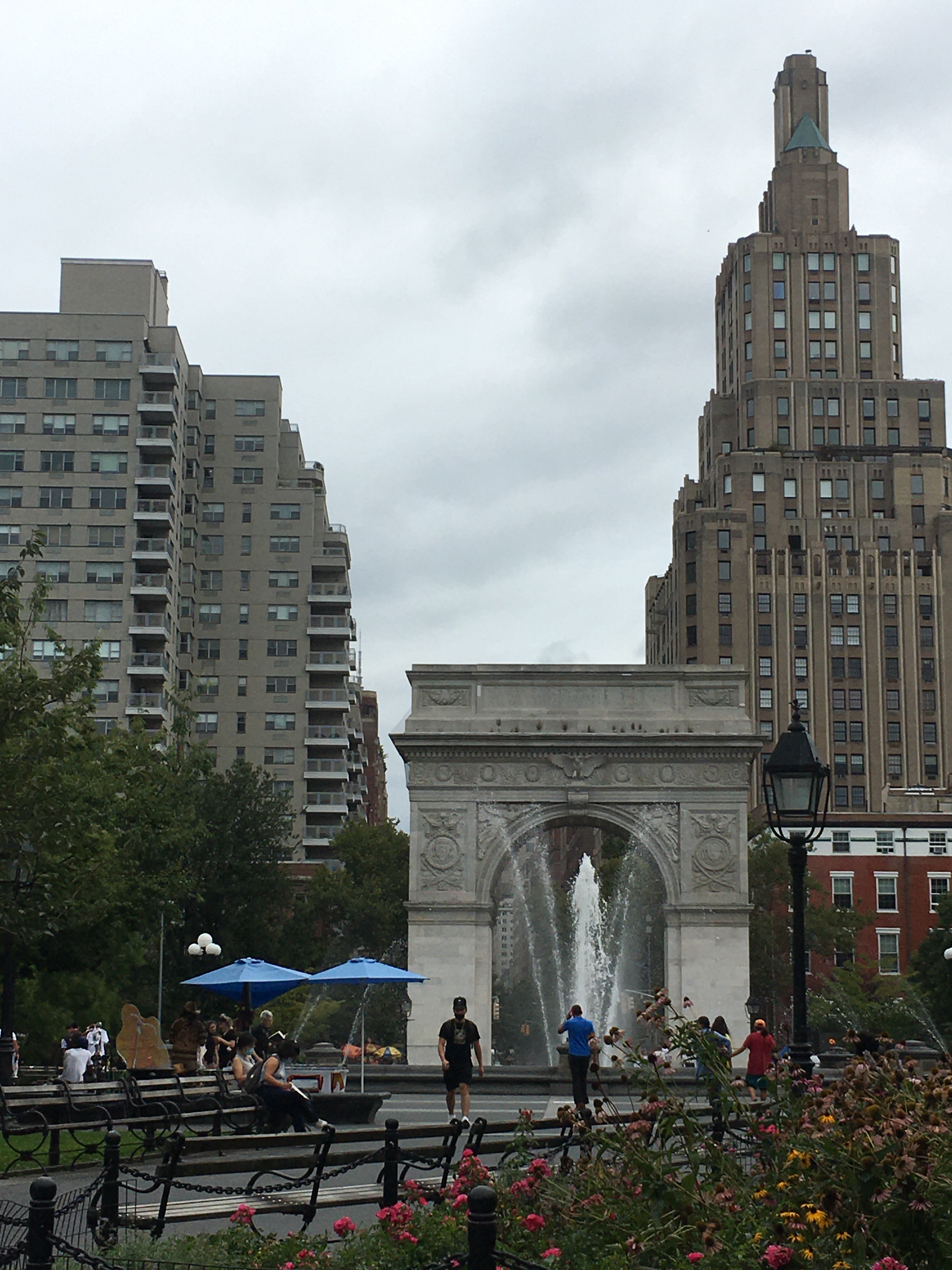 Washington Square Park in NYC with a nice view of buildings behind a fountain