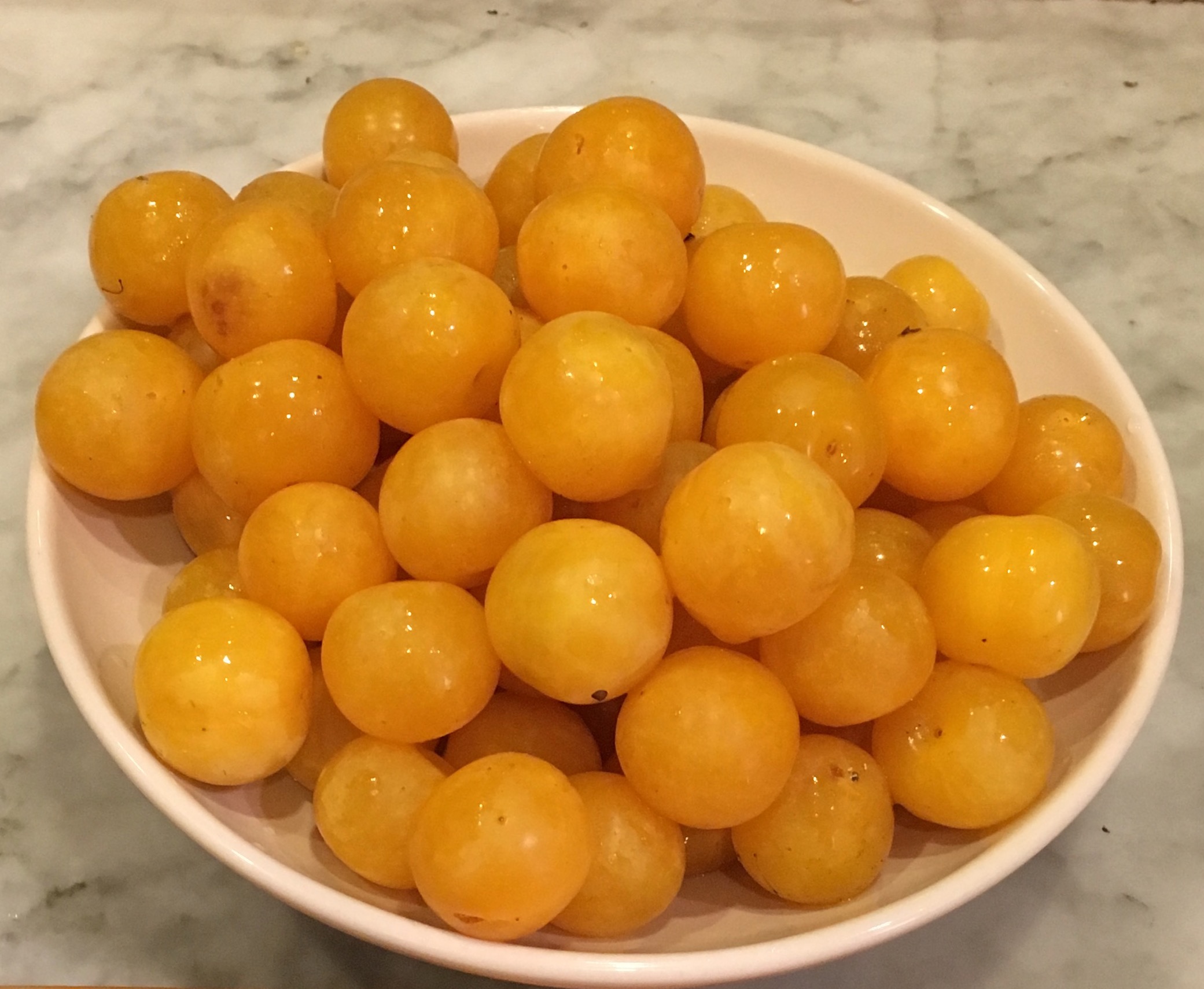 bowl of yellow plums