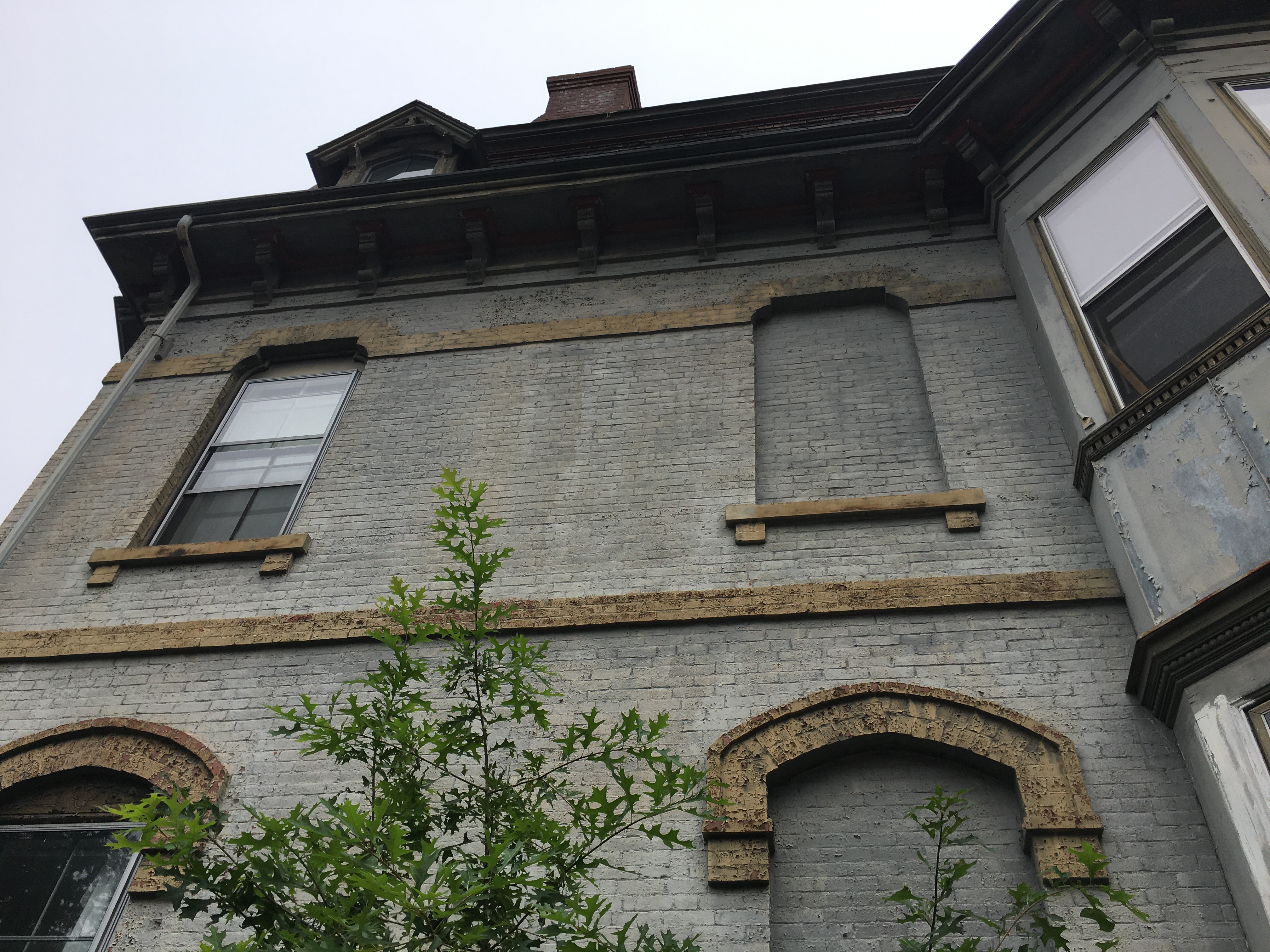 old gray brick building with beautiful details
