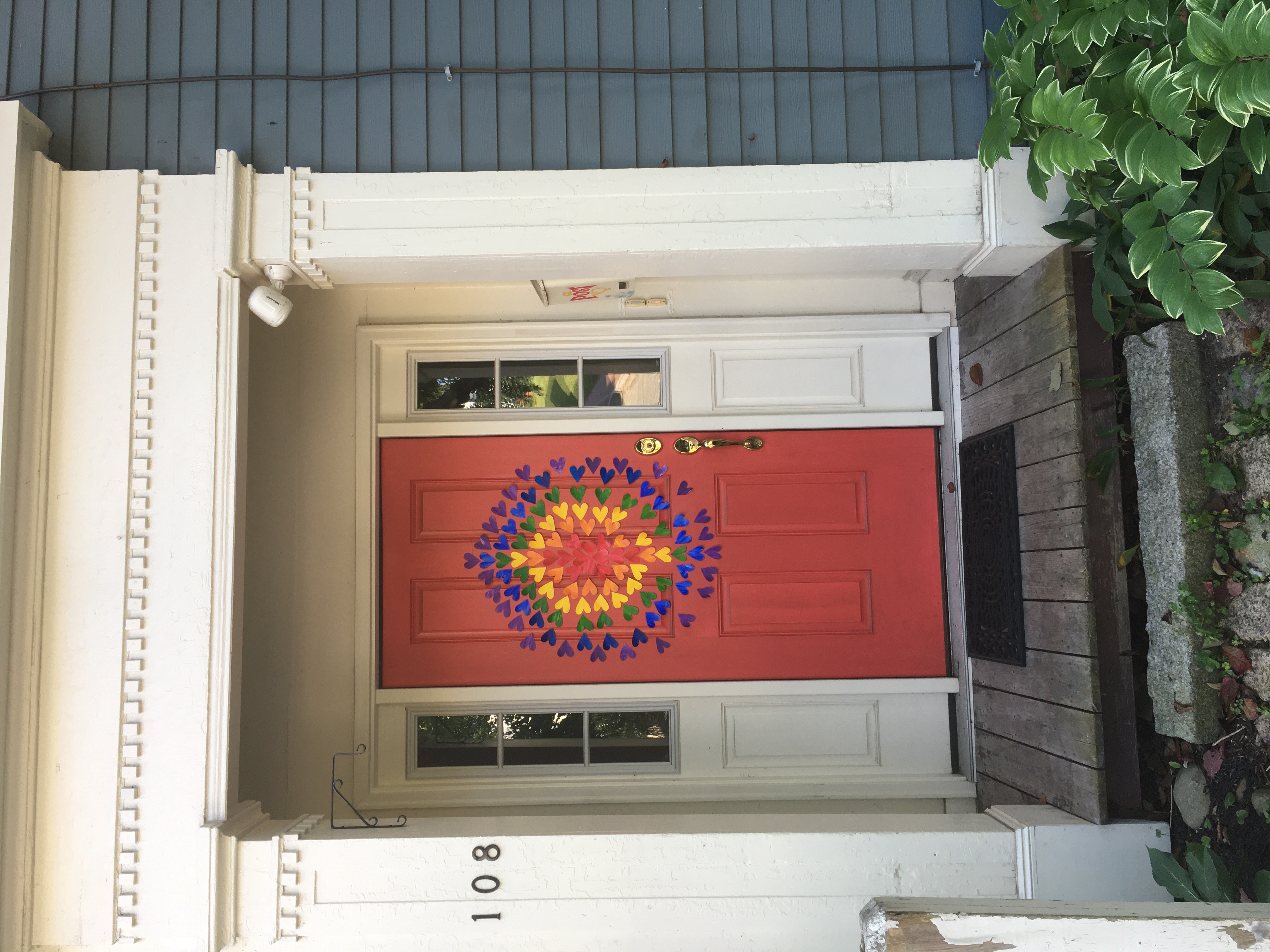 doorway with rainbow hearts radiating outwards
