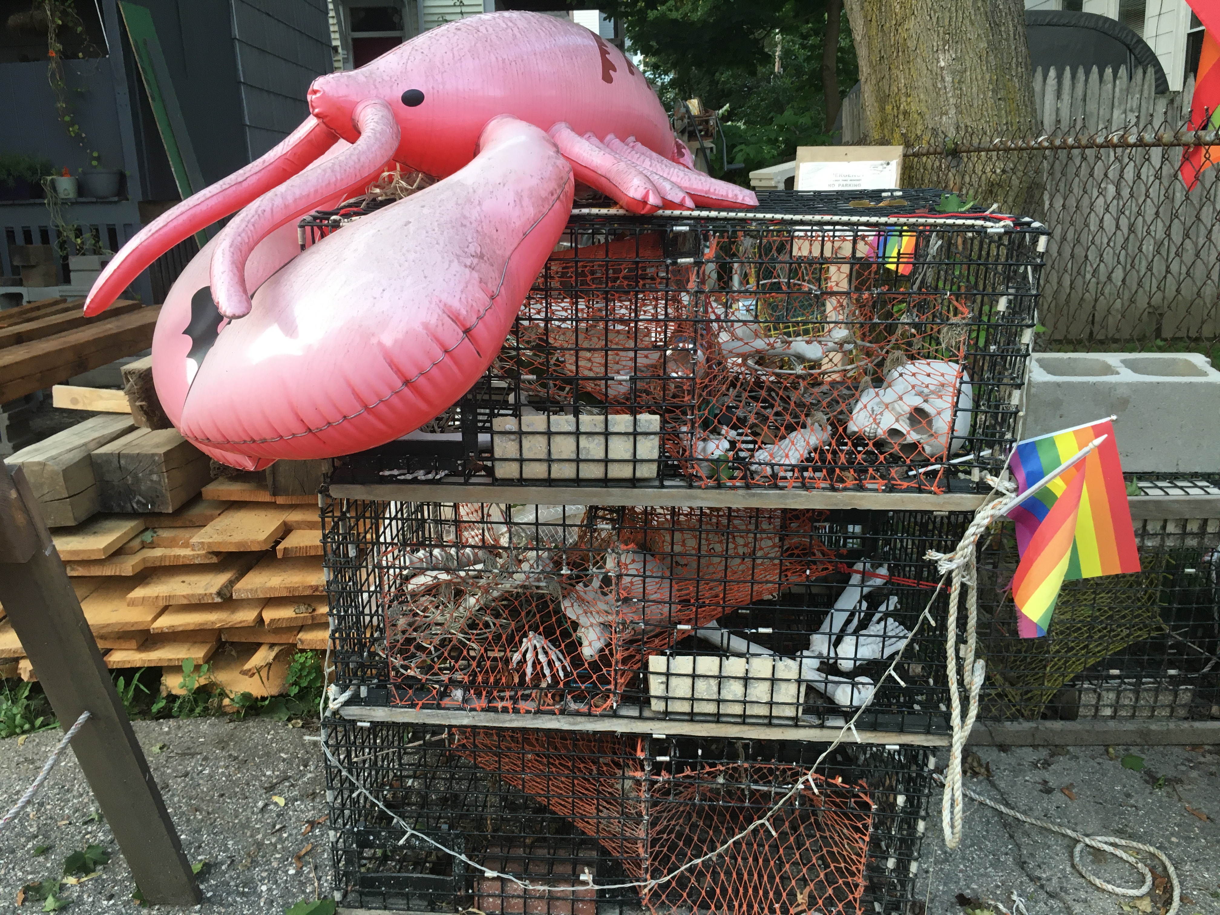 blow up lobster on lobster cages with human skeletons and booze bottles inside as bait. Halloween decorations