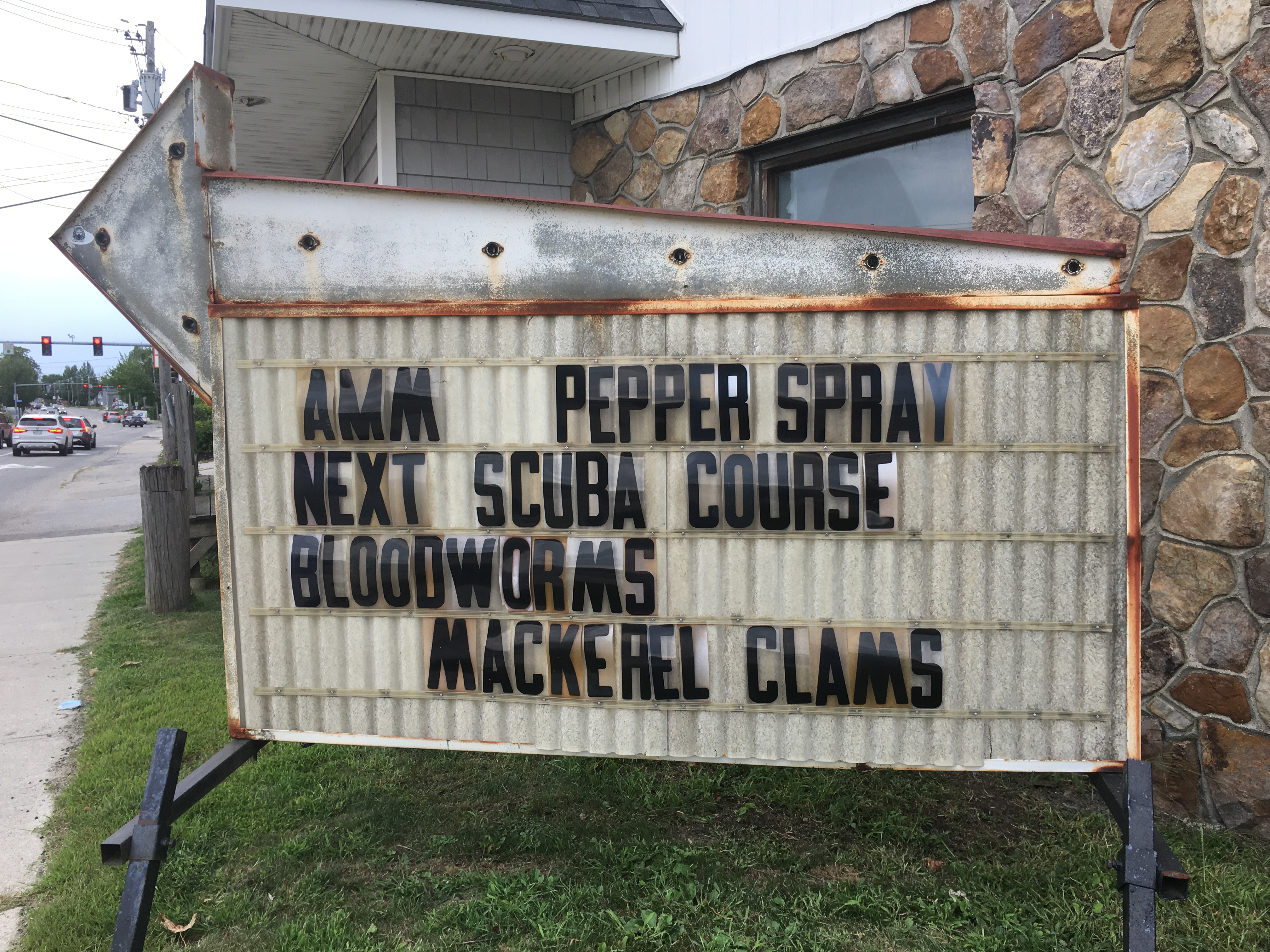 Sign that reads Ammo, pepper spray, next scuba course, bloodworms, mackerel clams