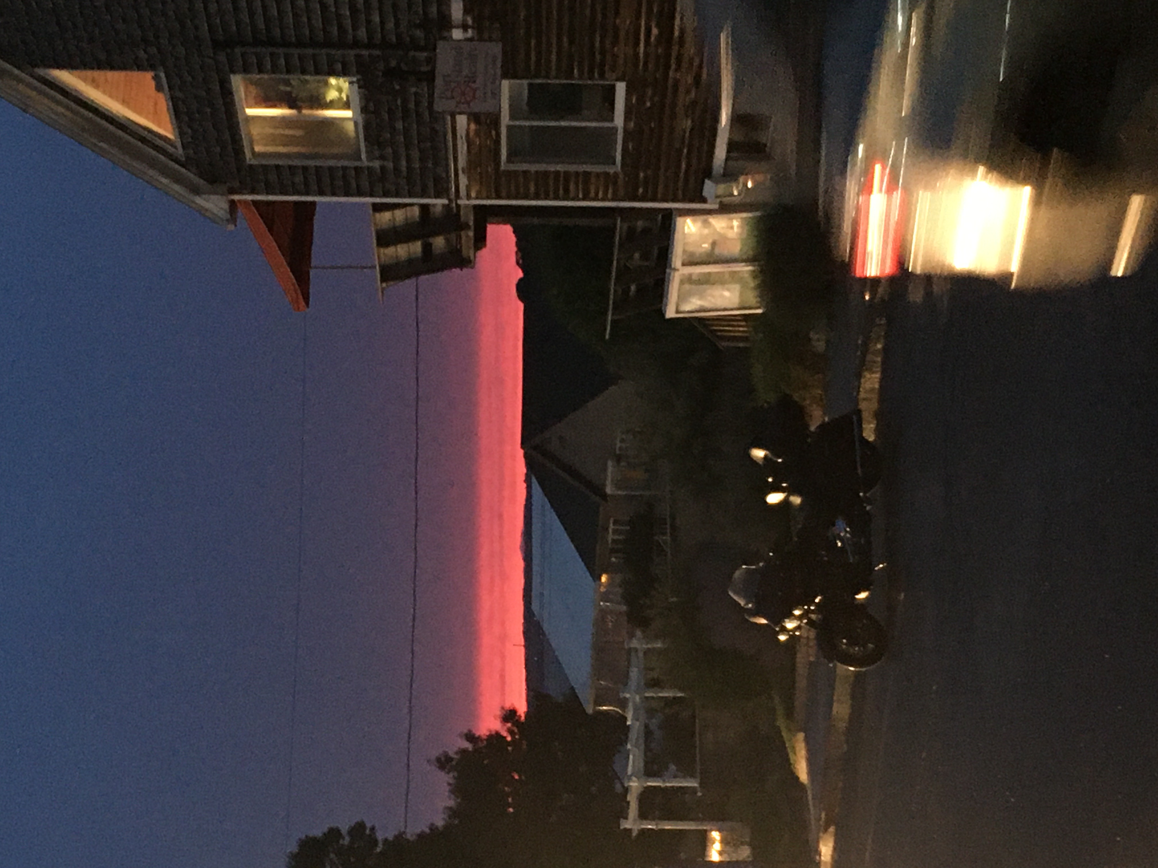 Dark sky with a line of hot pink sunset in front of a lobster shack