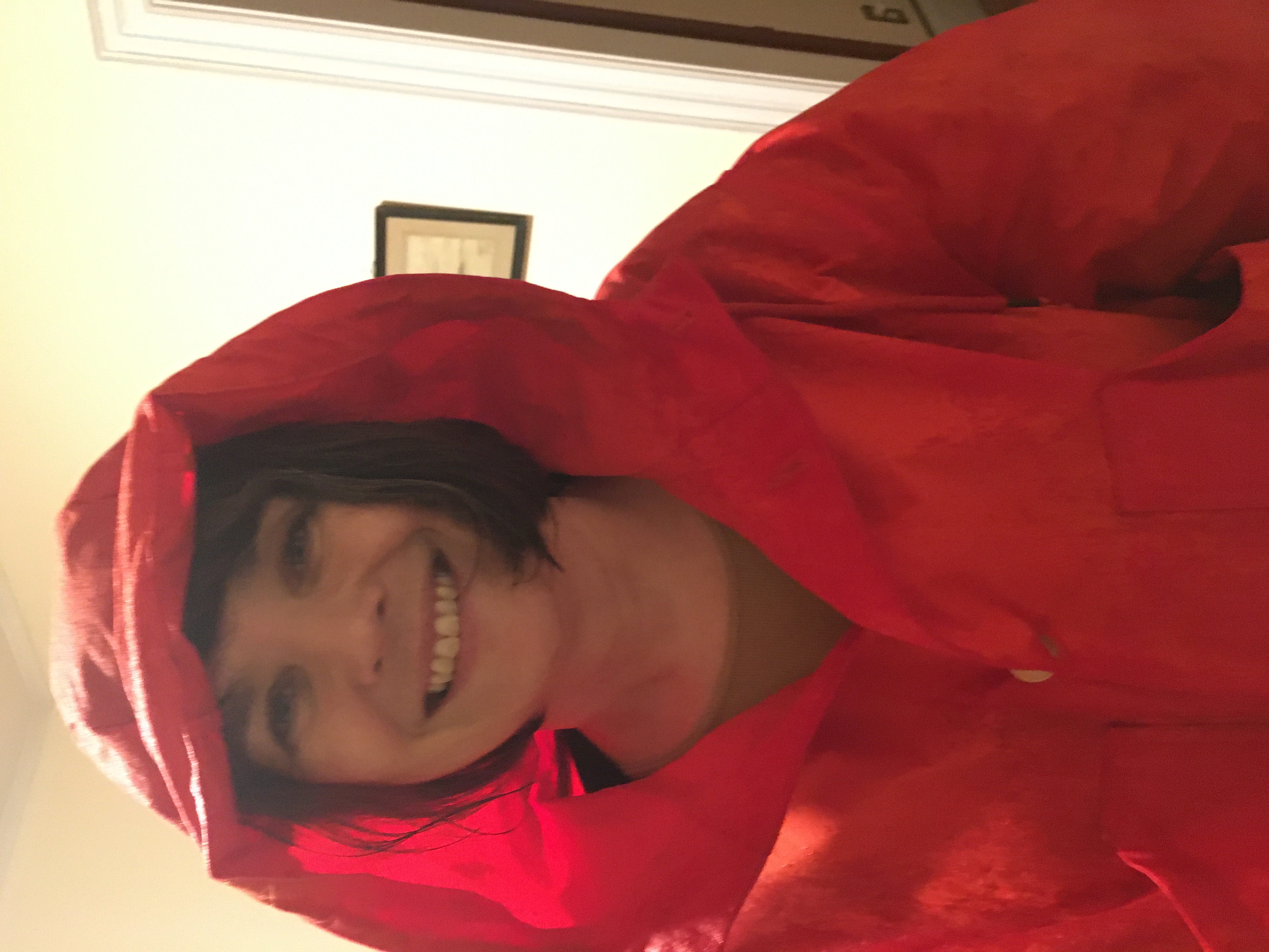 Woman smiling with short hair in in red raincoat