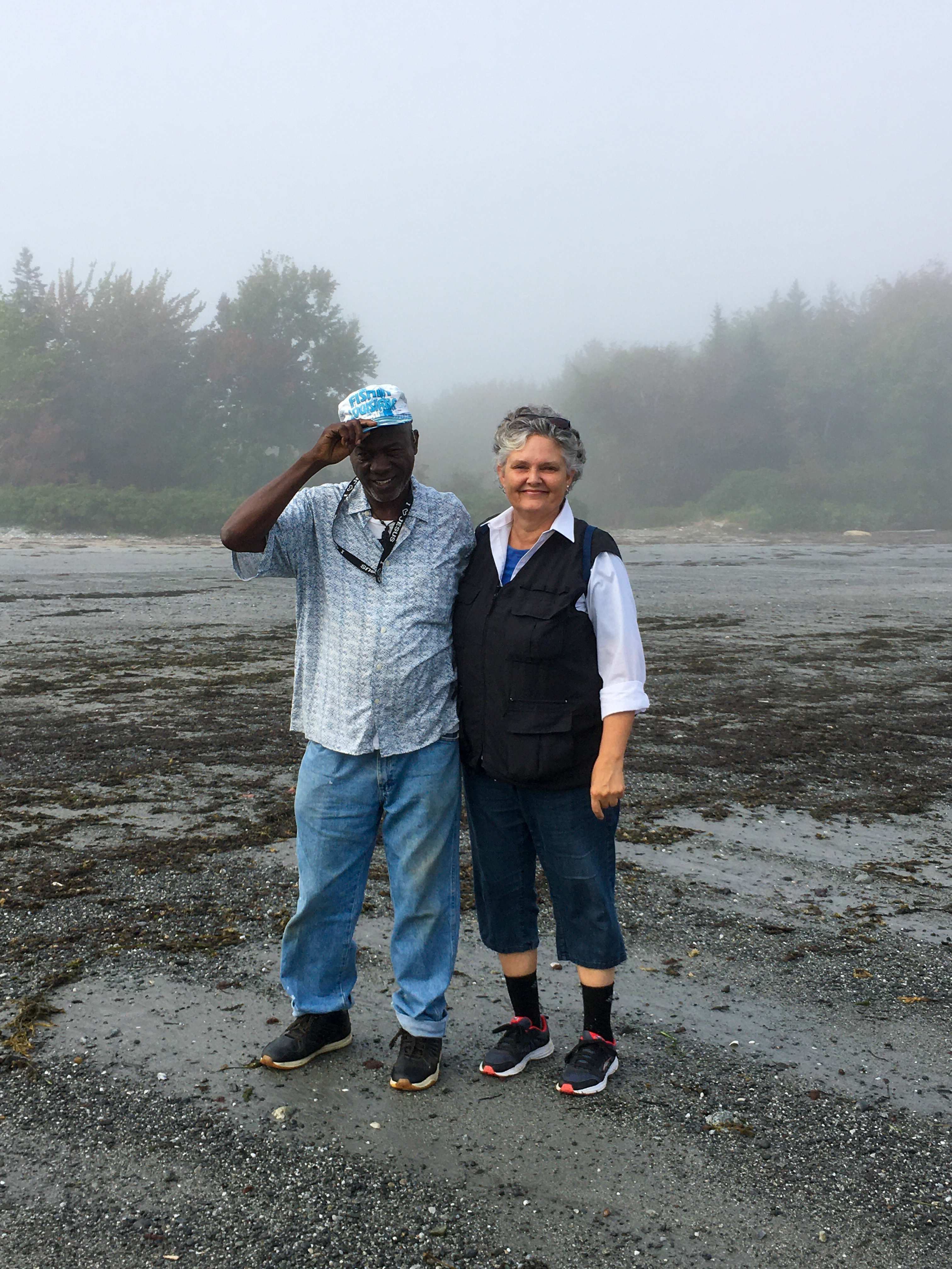 man and woman standing on a beach