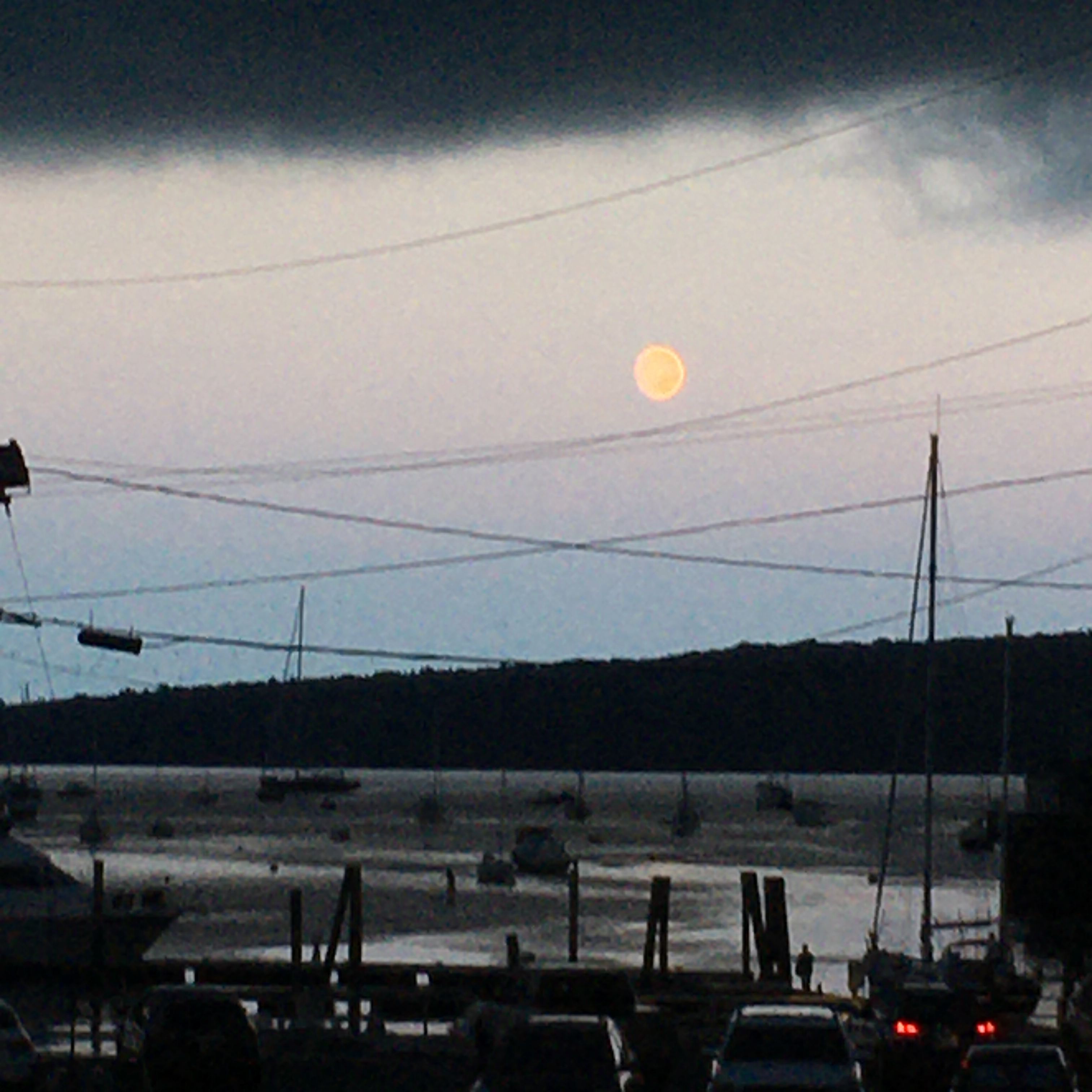 moon coming up over the water