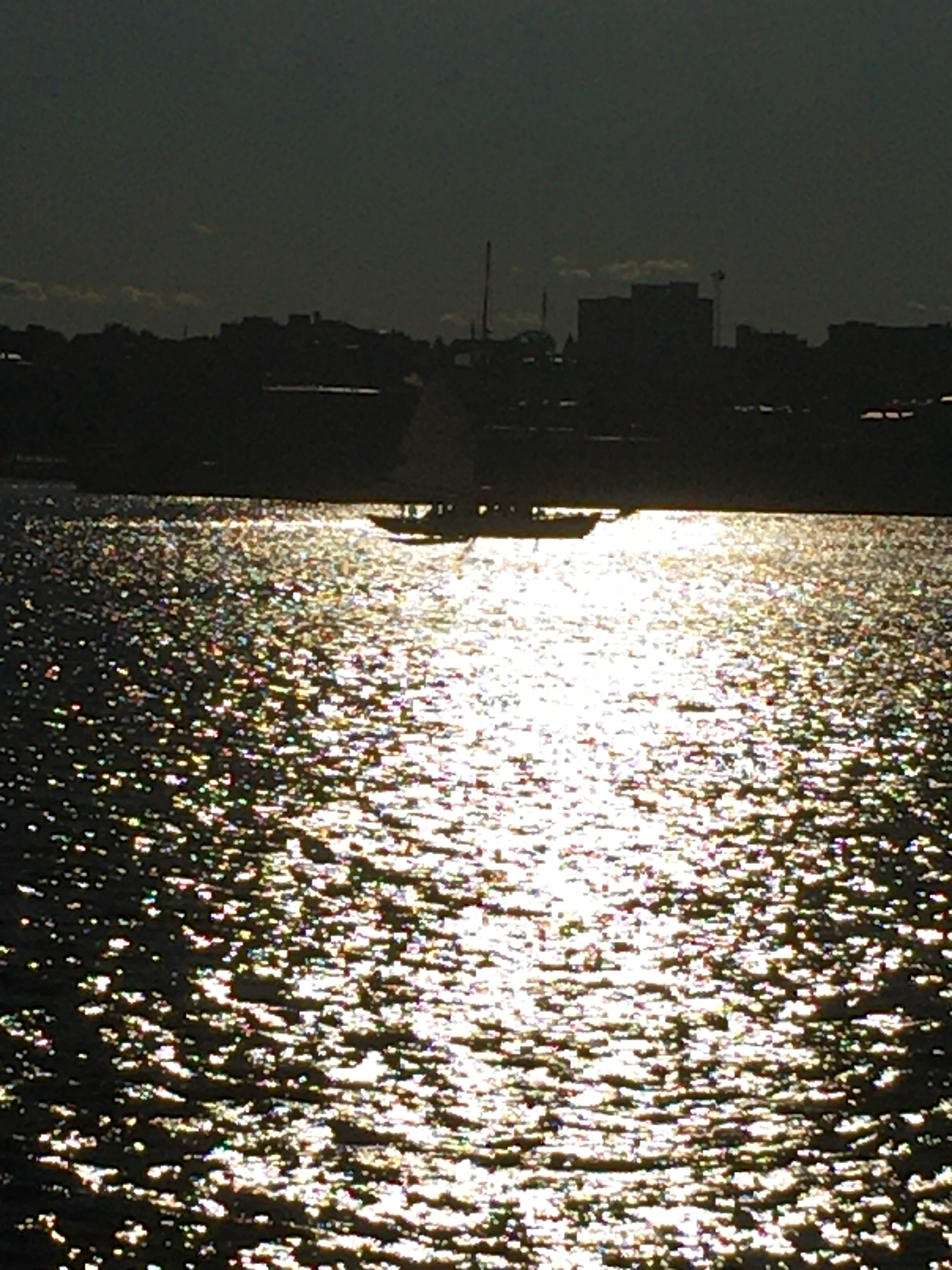 bright light with a boat outlined in the sunset