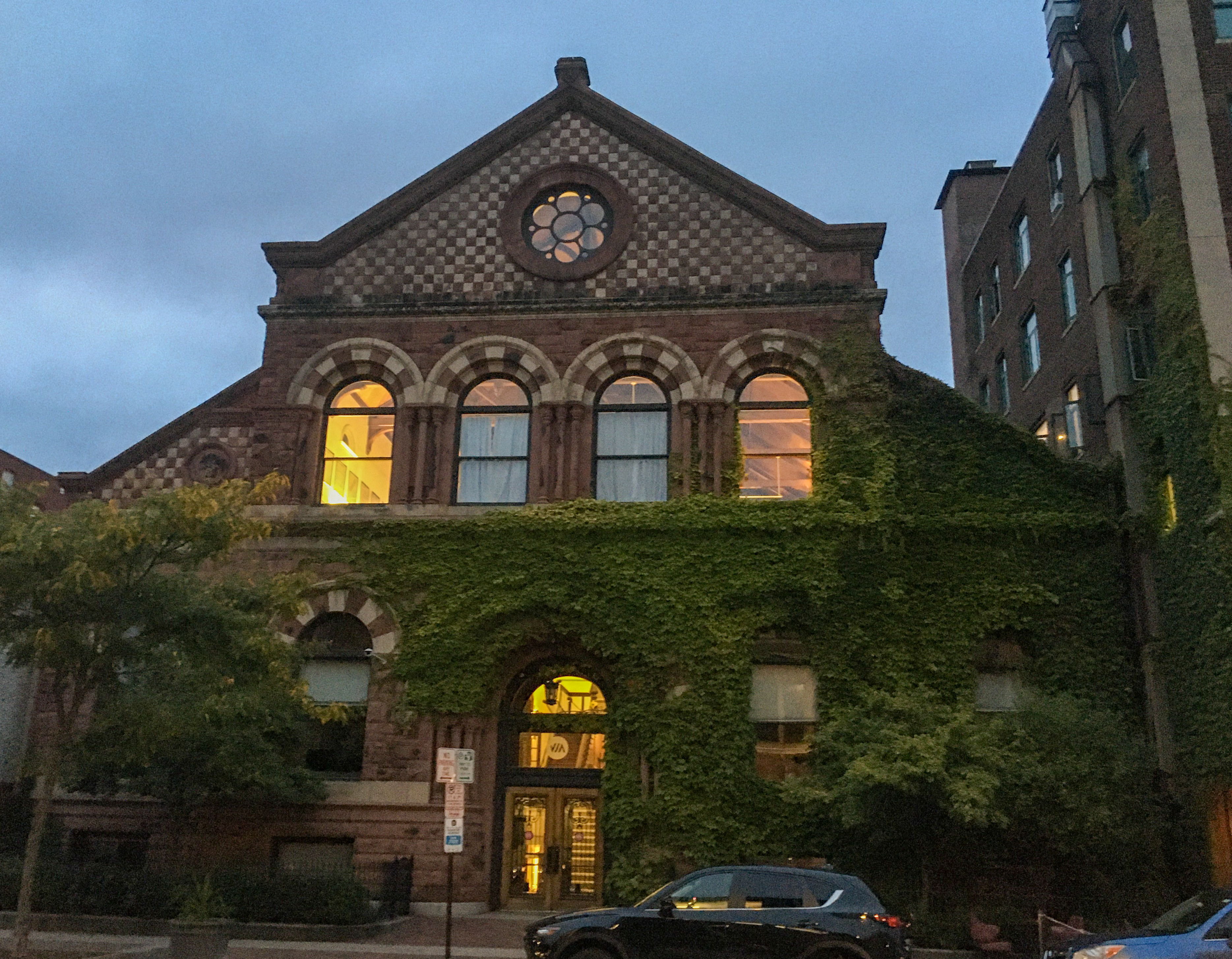 beautiful brick building with ivy covering part of it