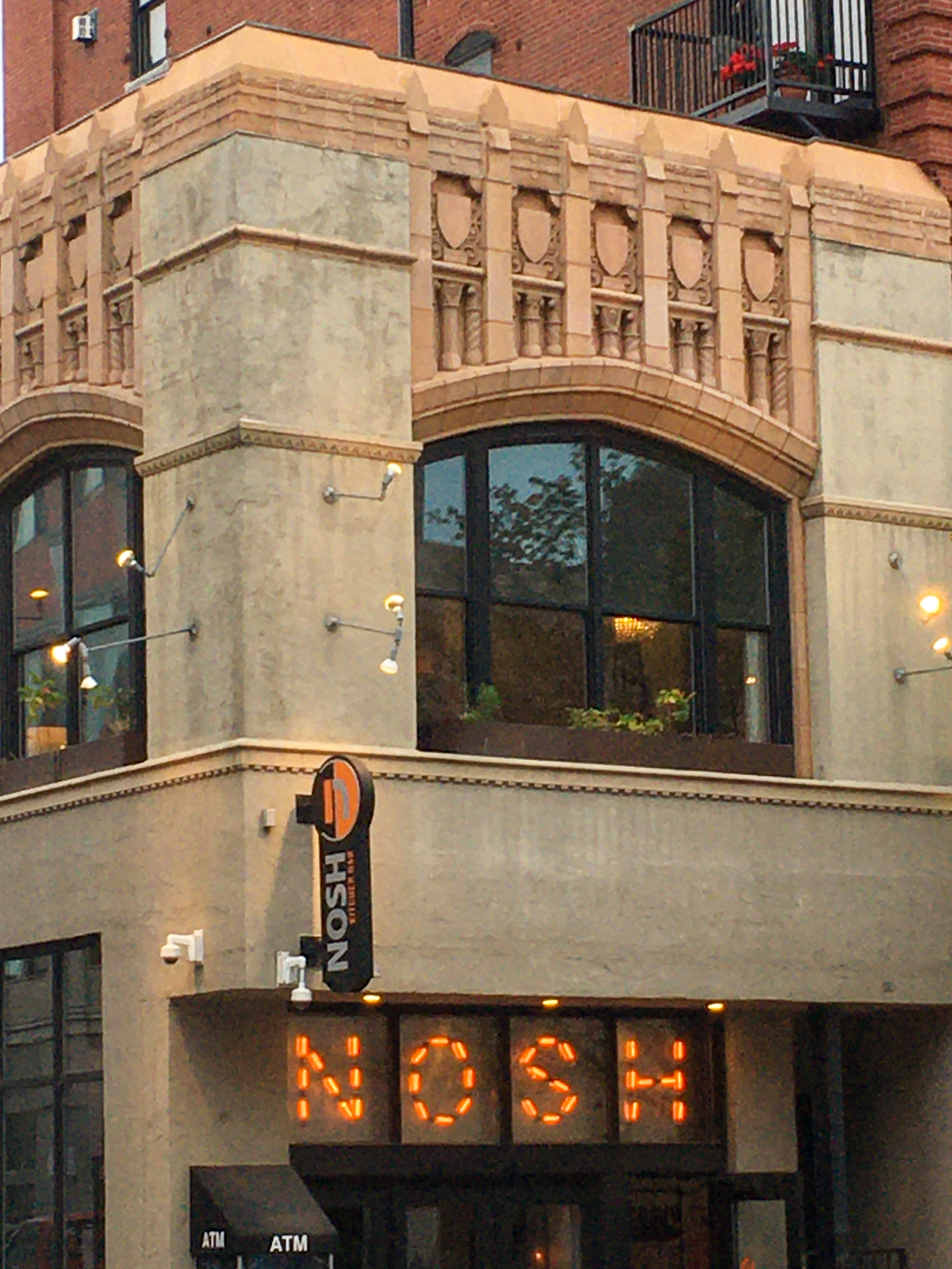 art deco building with NOSH written in lights