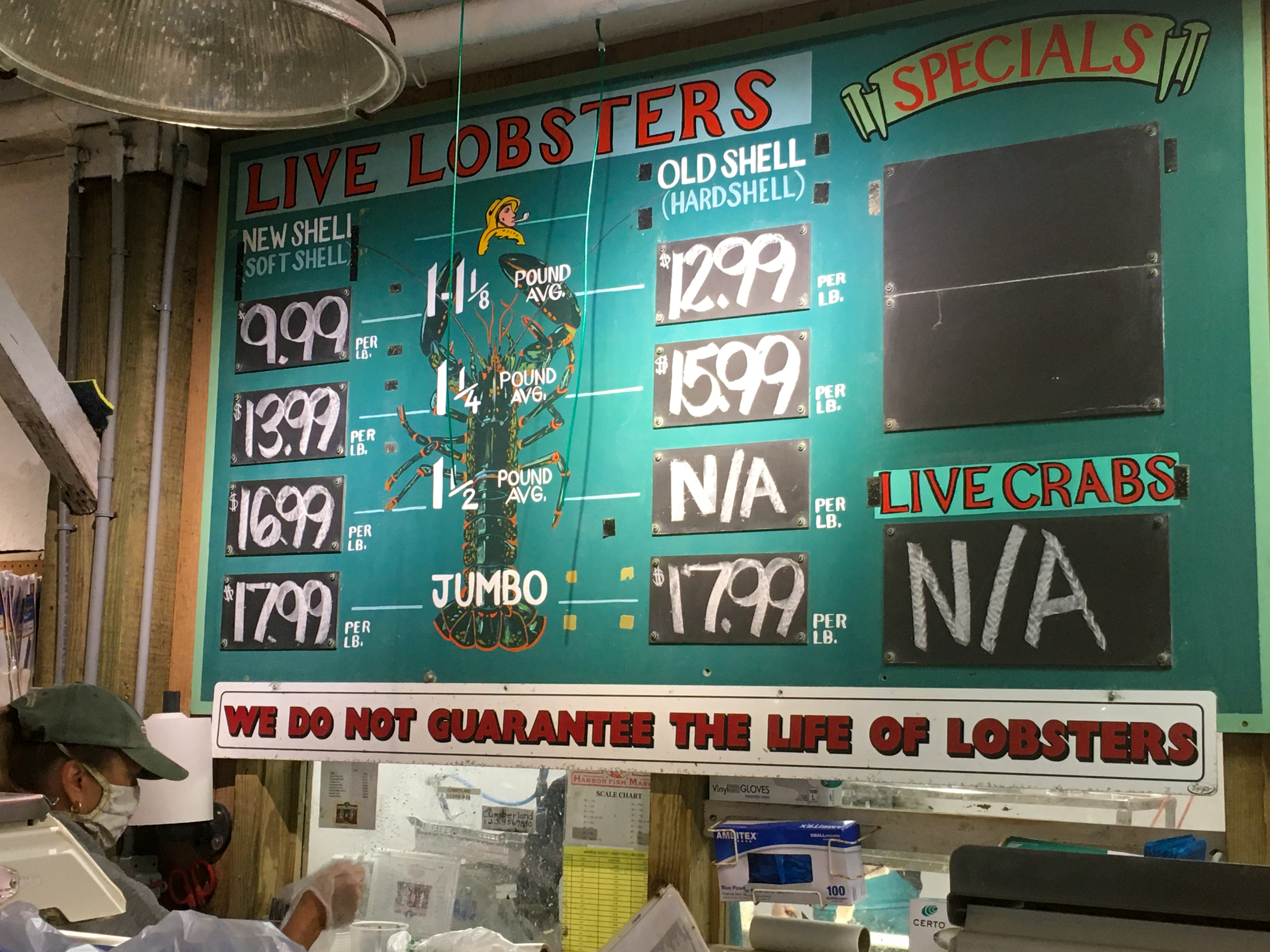 Lobster prices on a teal board