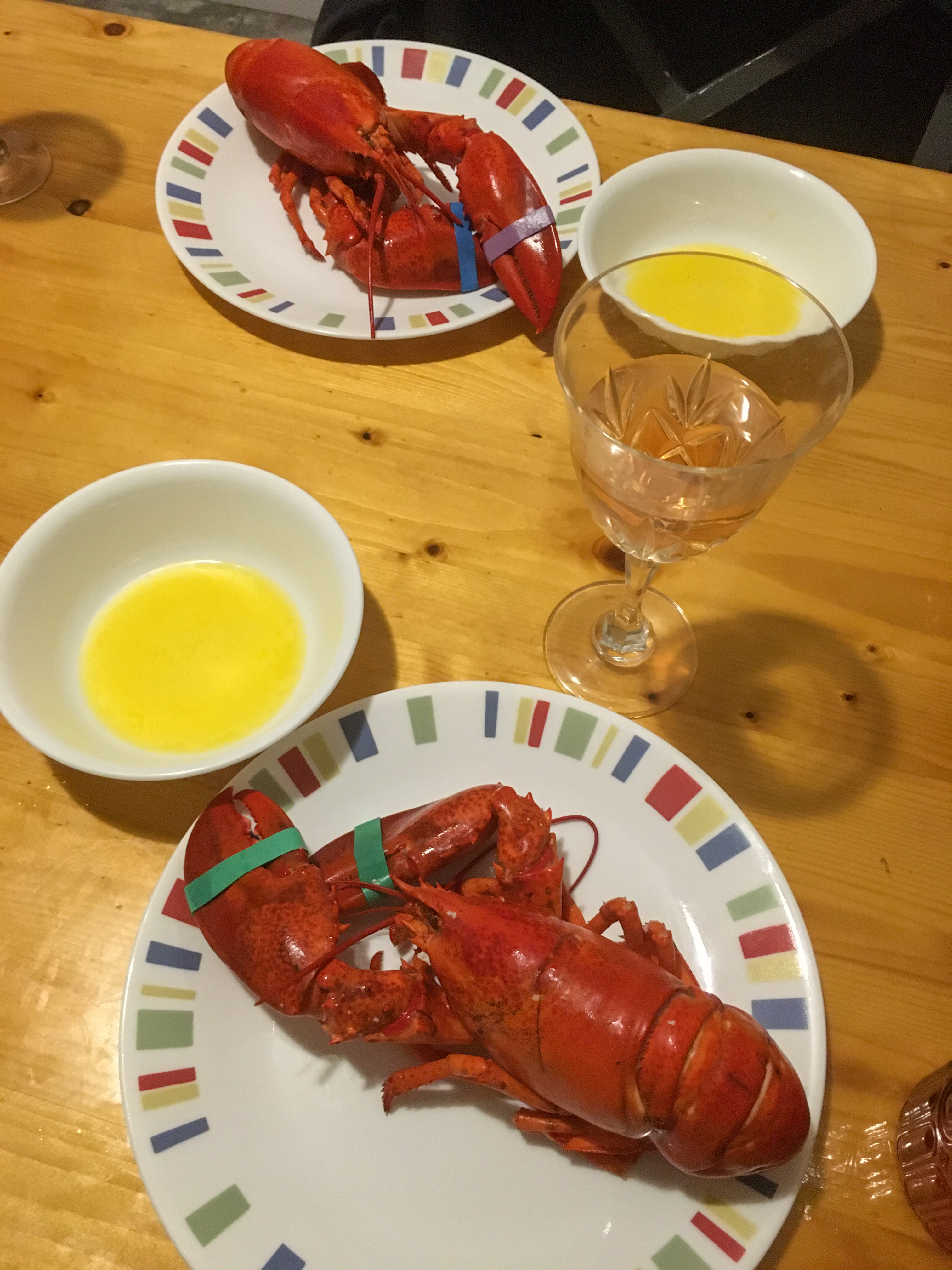lobster with butter dishes and wine glasses with rosé