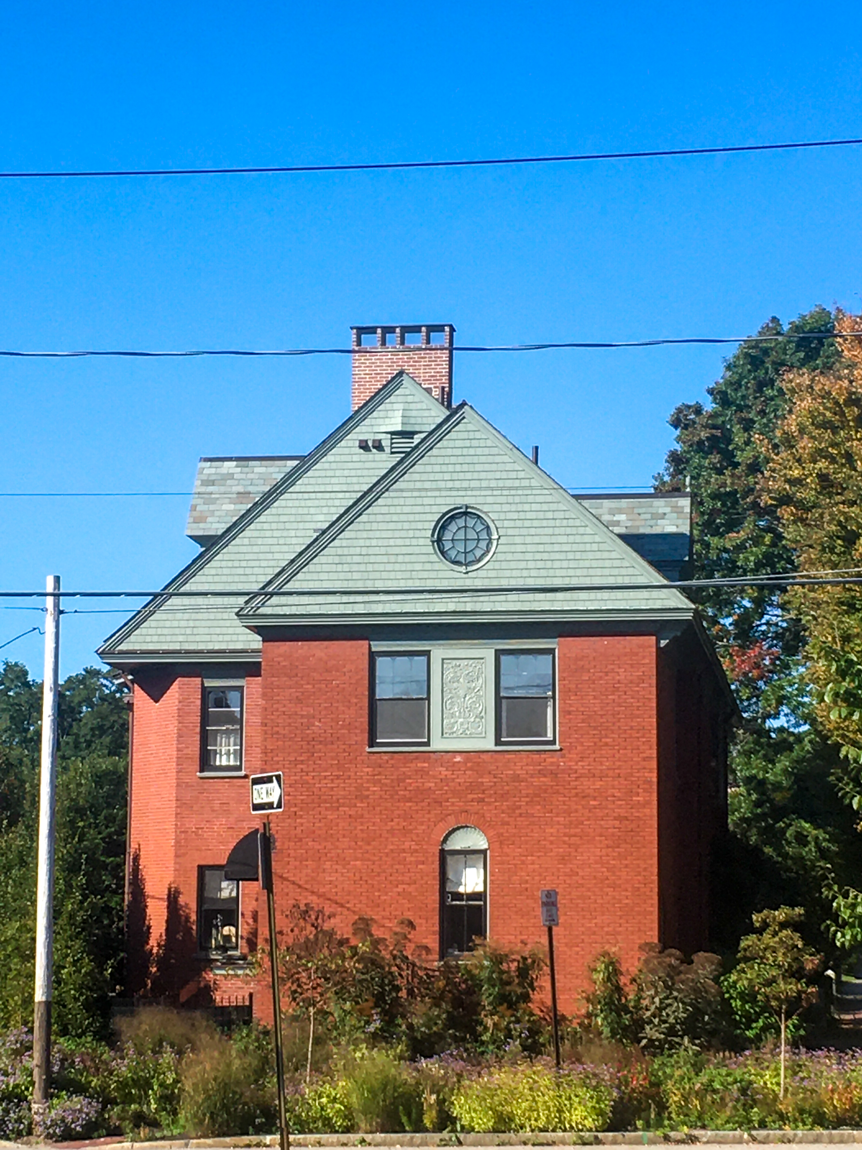 brick house with a round window at the top