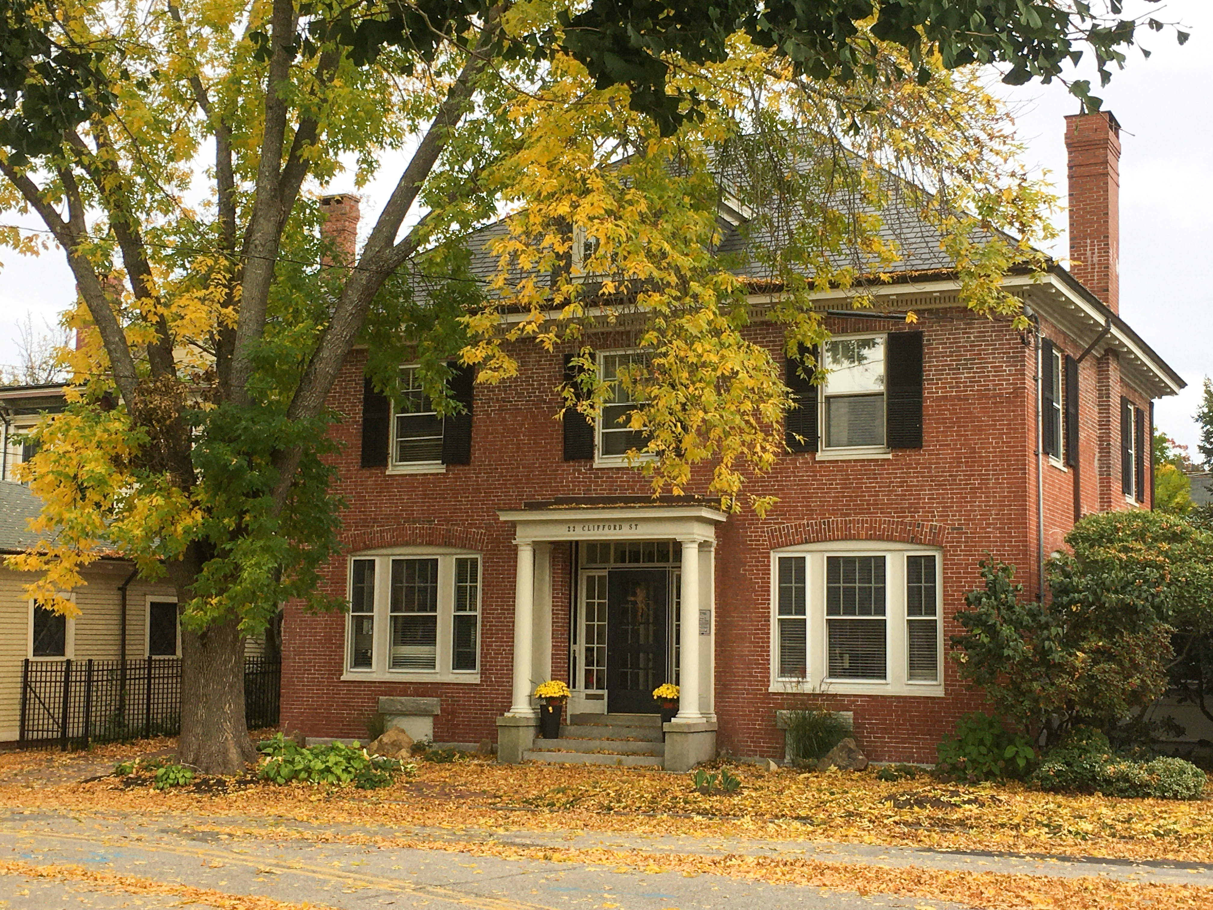 brick house with yellow trees