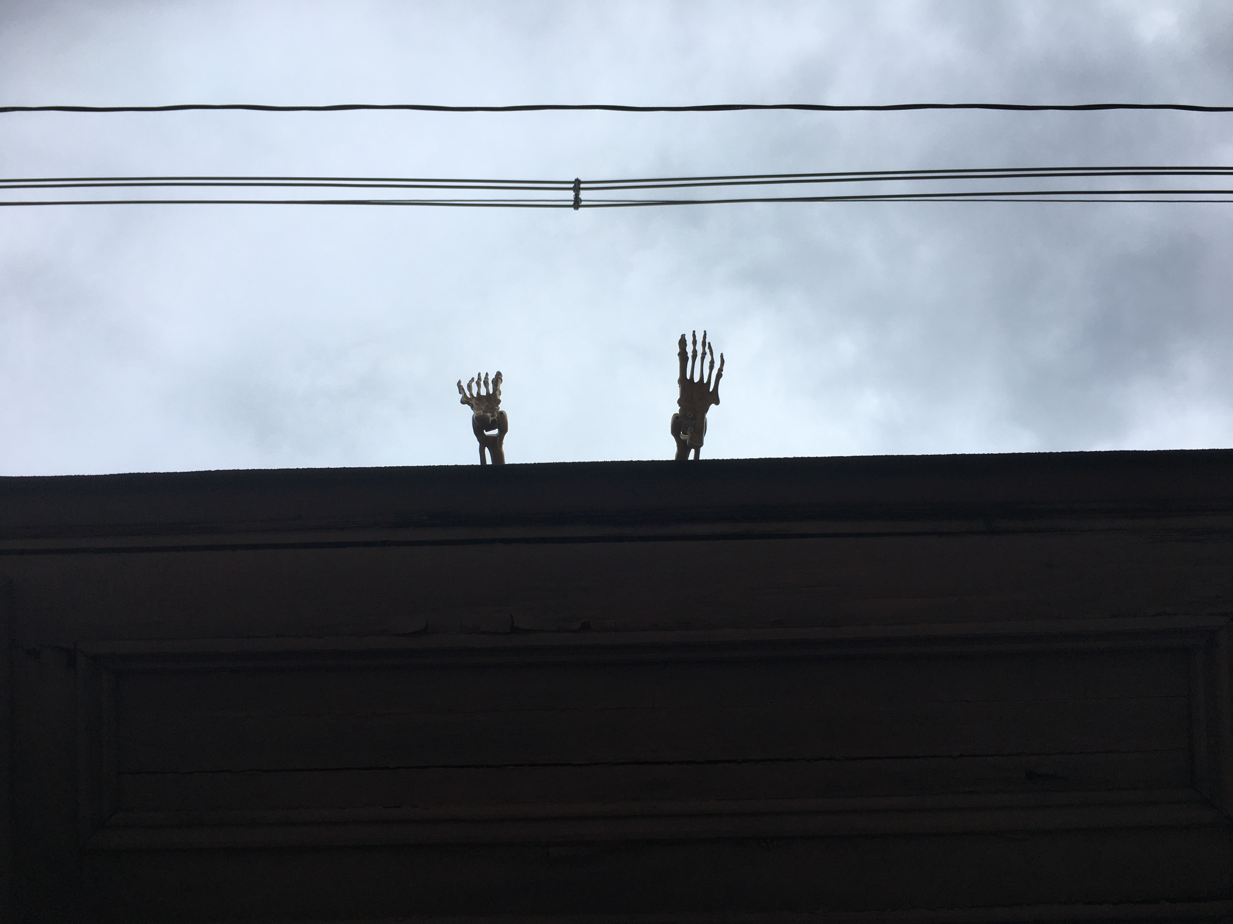 skeletons feet hanging off the roof