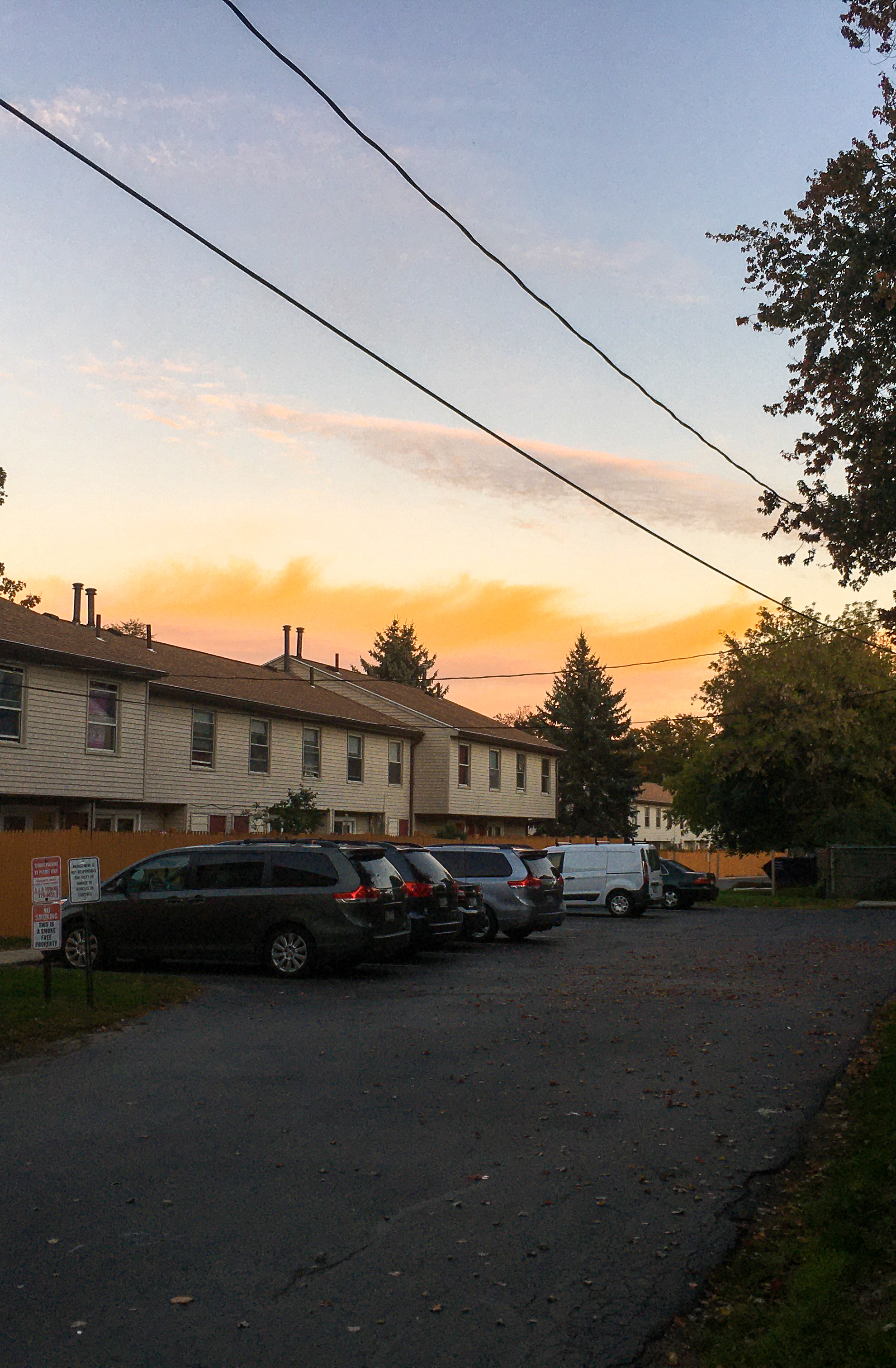 sunset with buildings and cars lined up