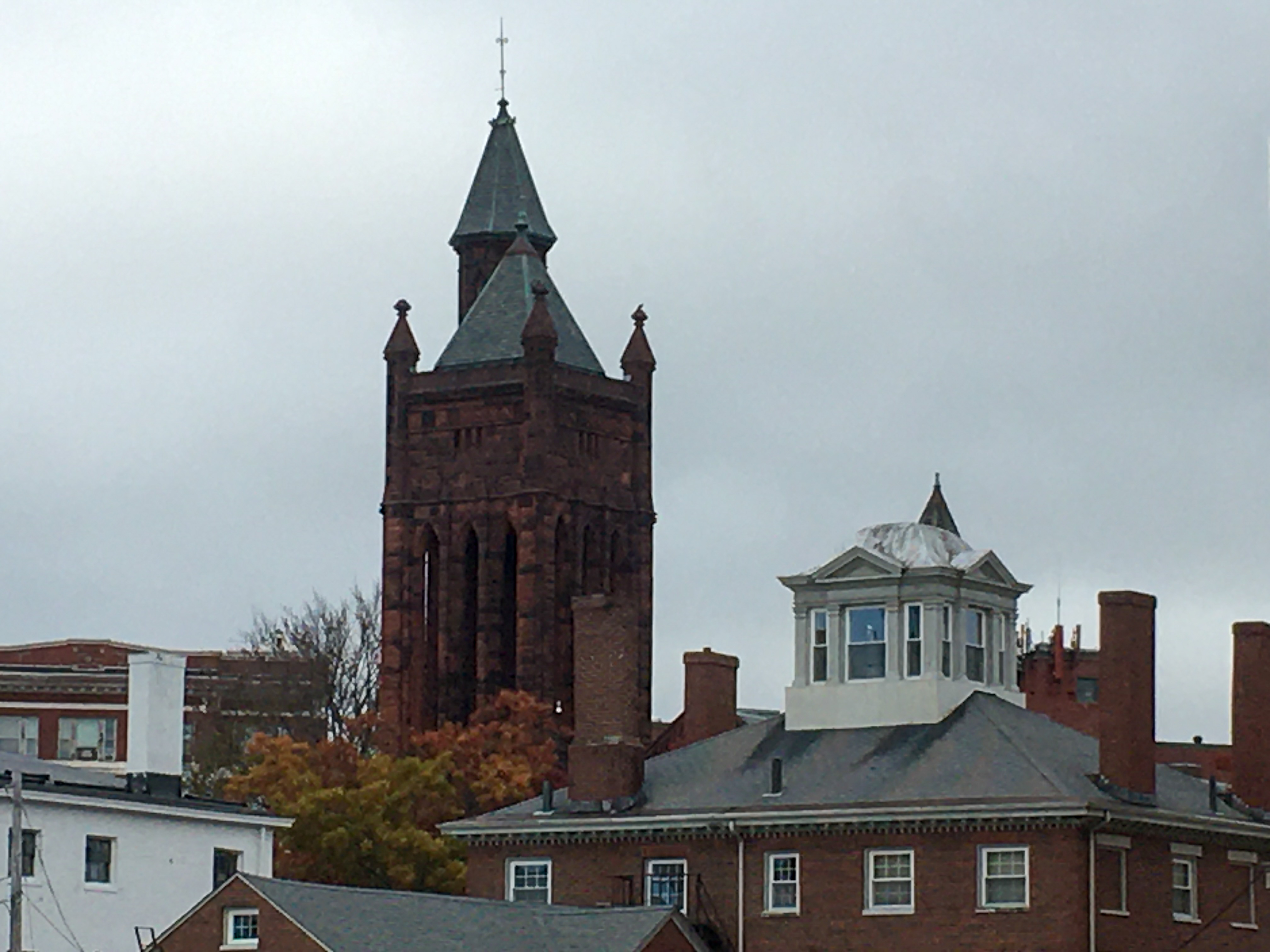 brick buildings with copper spires that are green with age