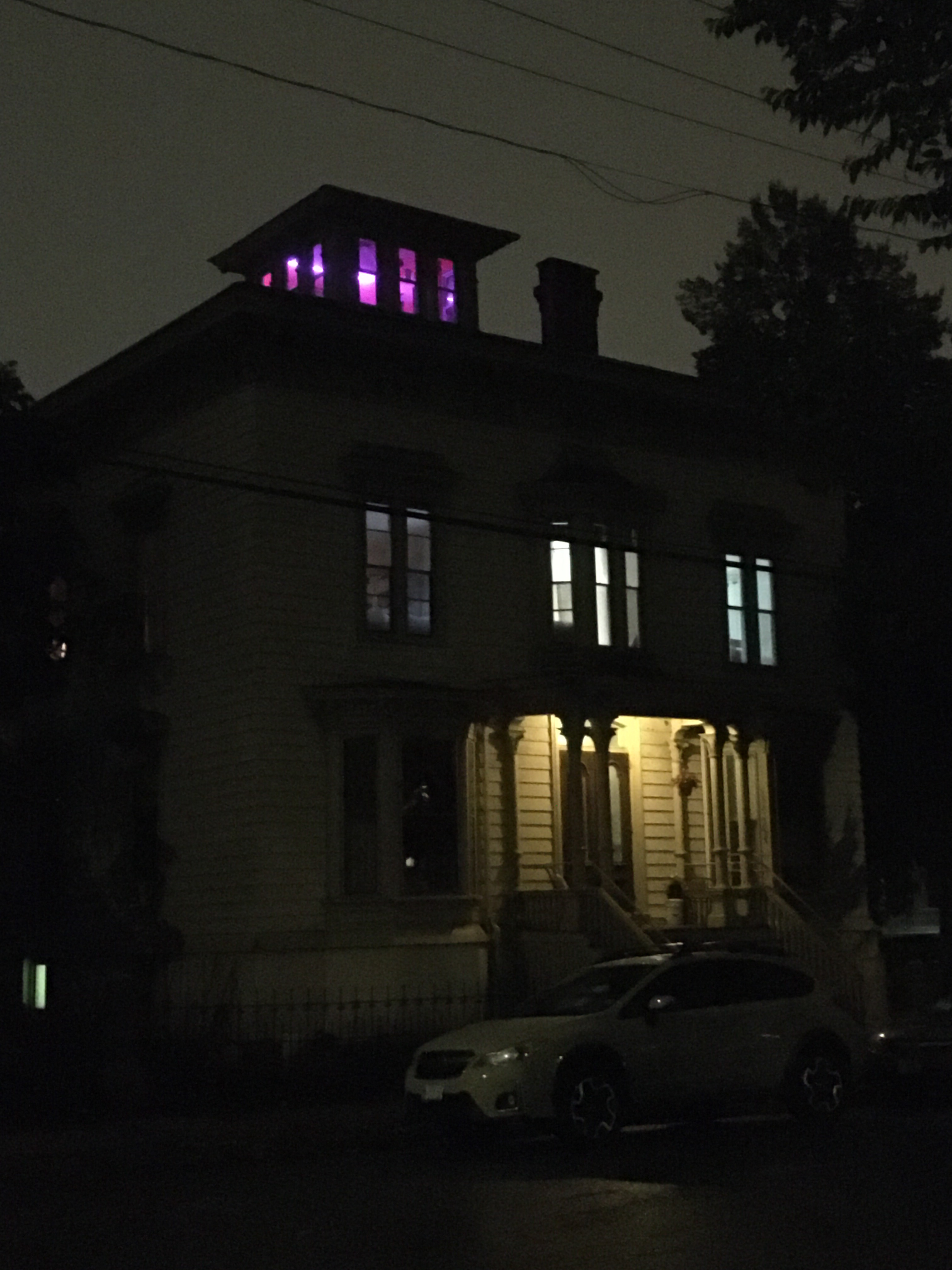 large square house with purple lights on top