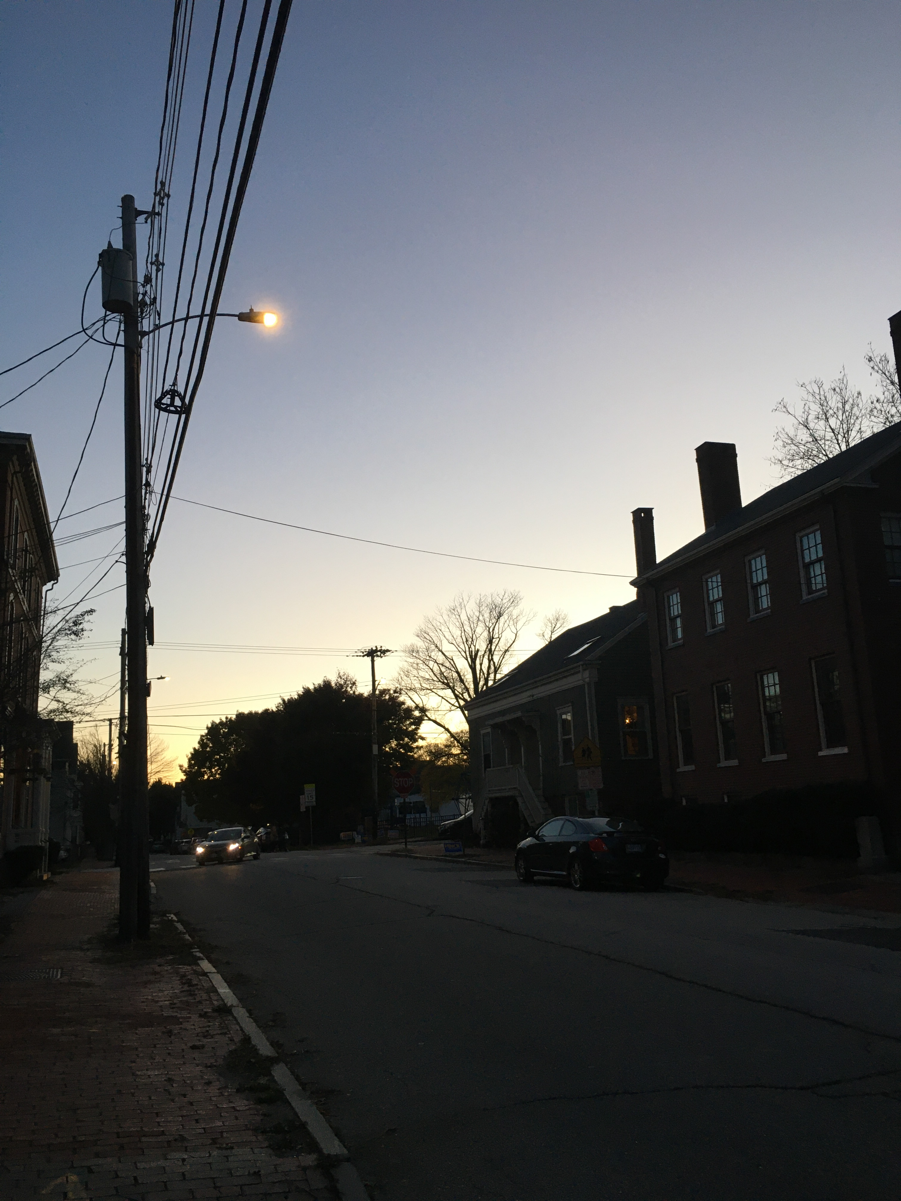 twilight with houses and wires catching the light