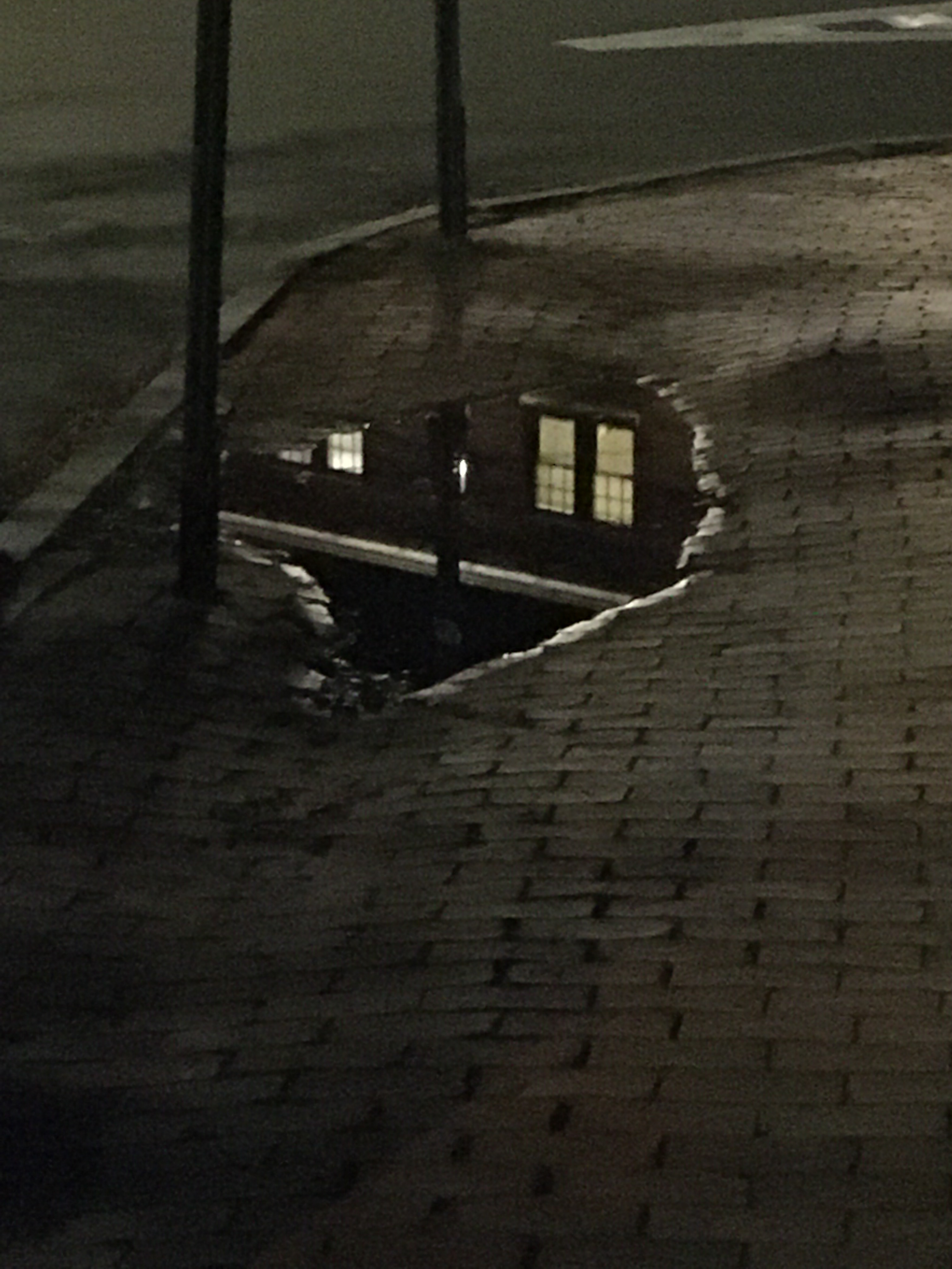 reflection of windows in a puddle from the rain