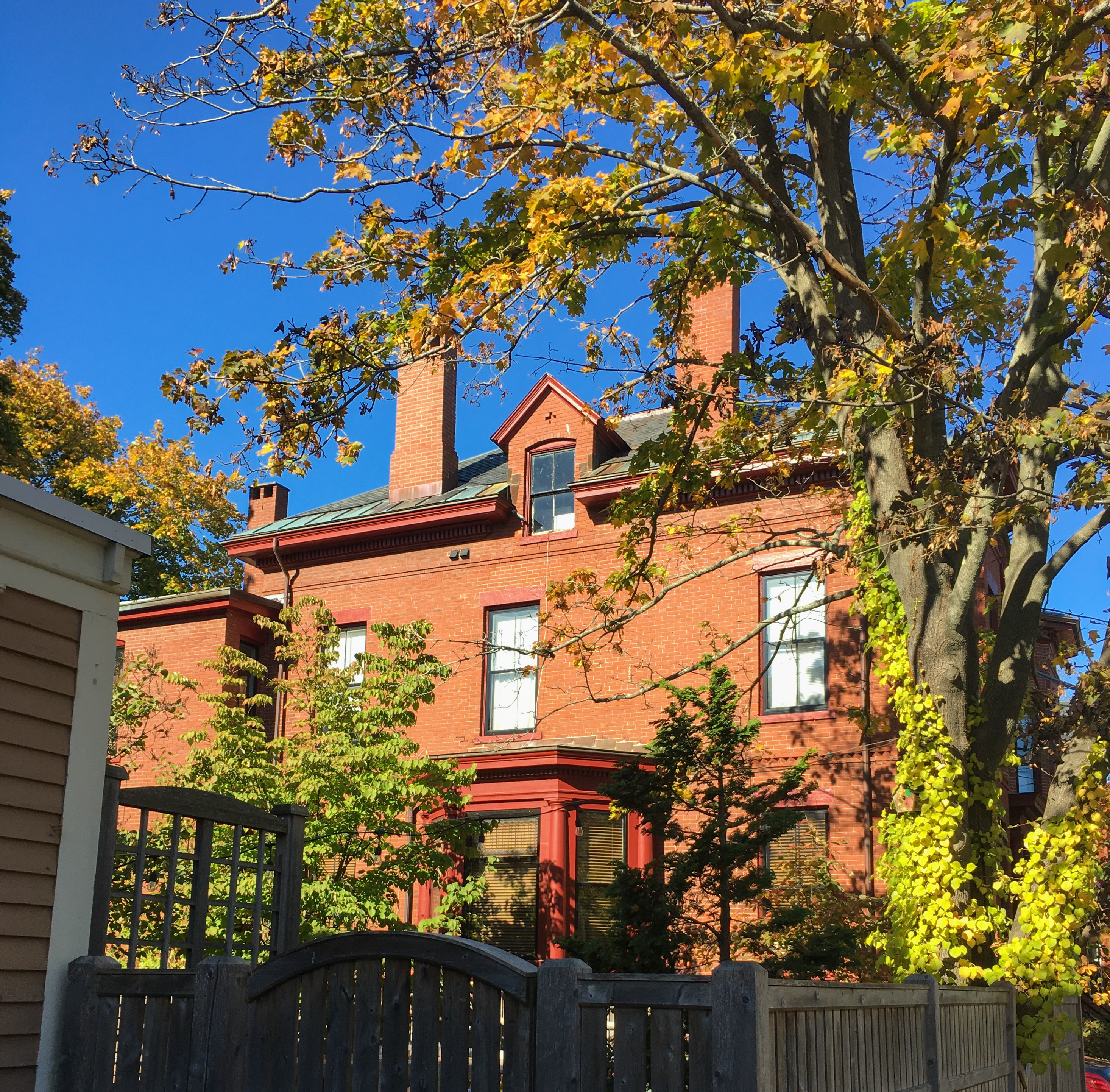 beautiful brick house with red trim