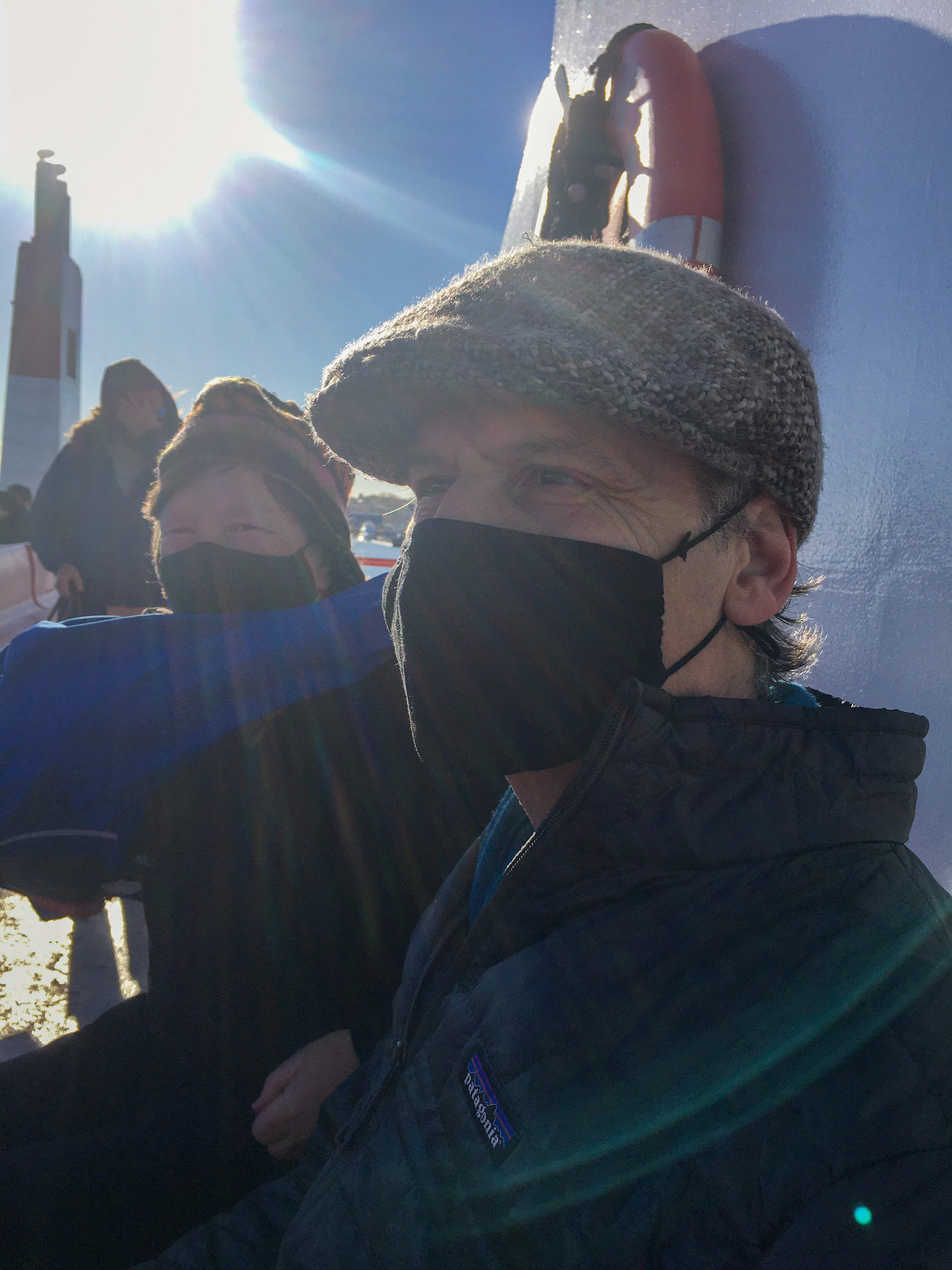 man and woman masked with the sun behind them