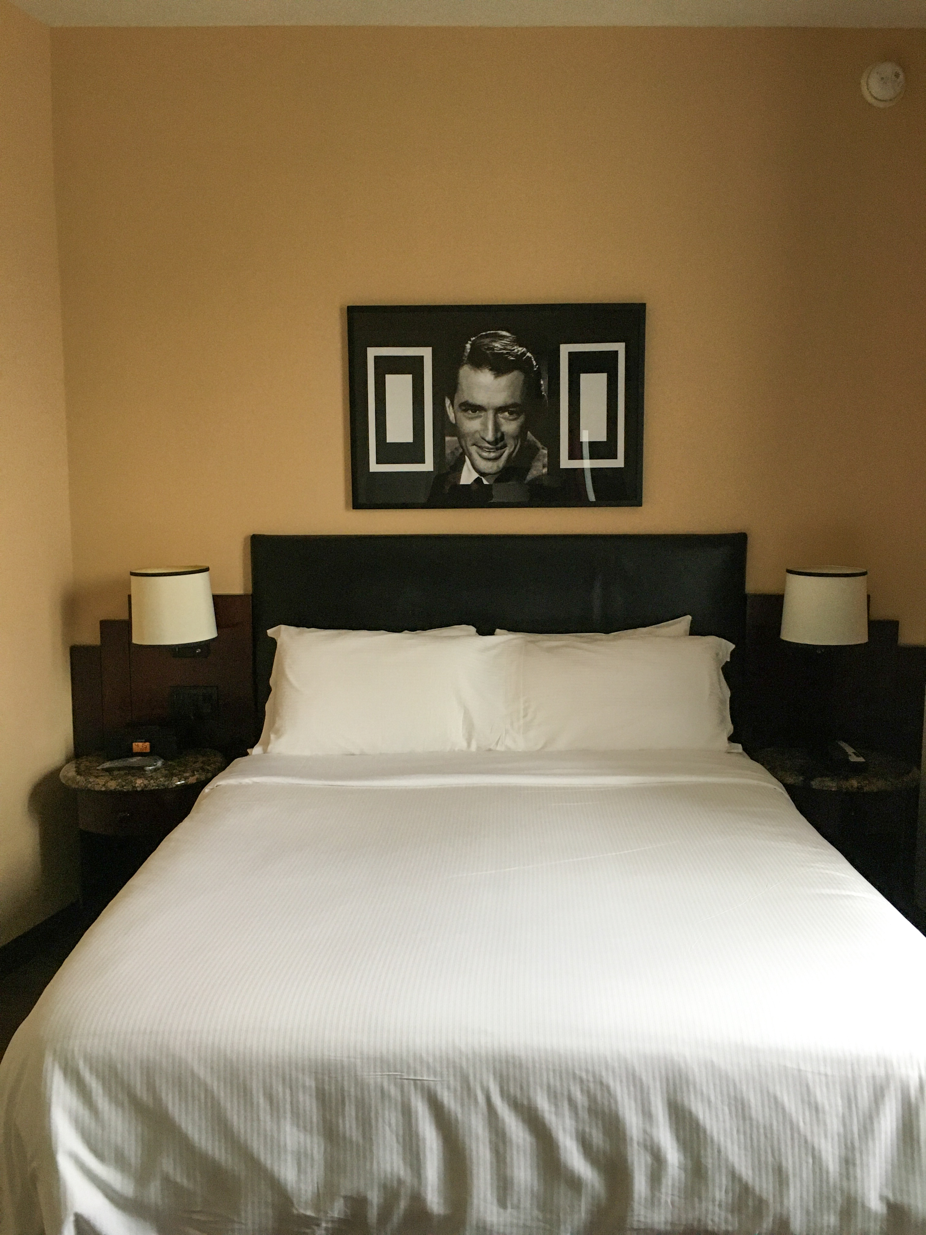 hotel room with bed with Carey Grant