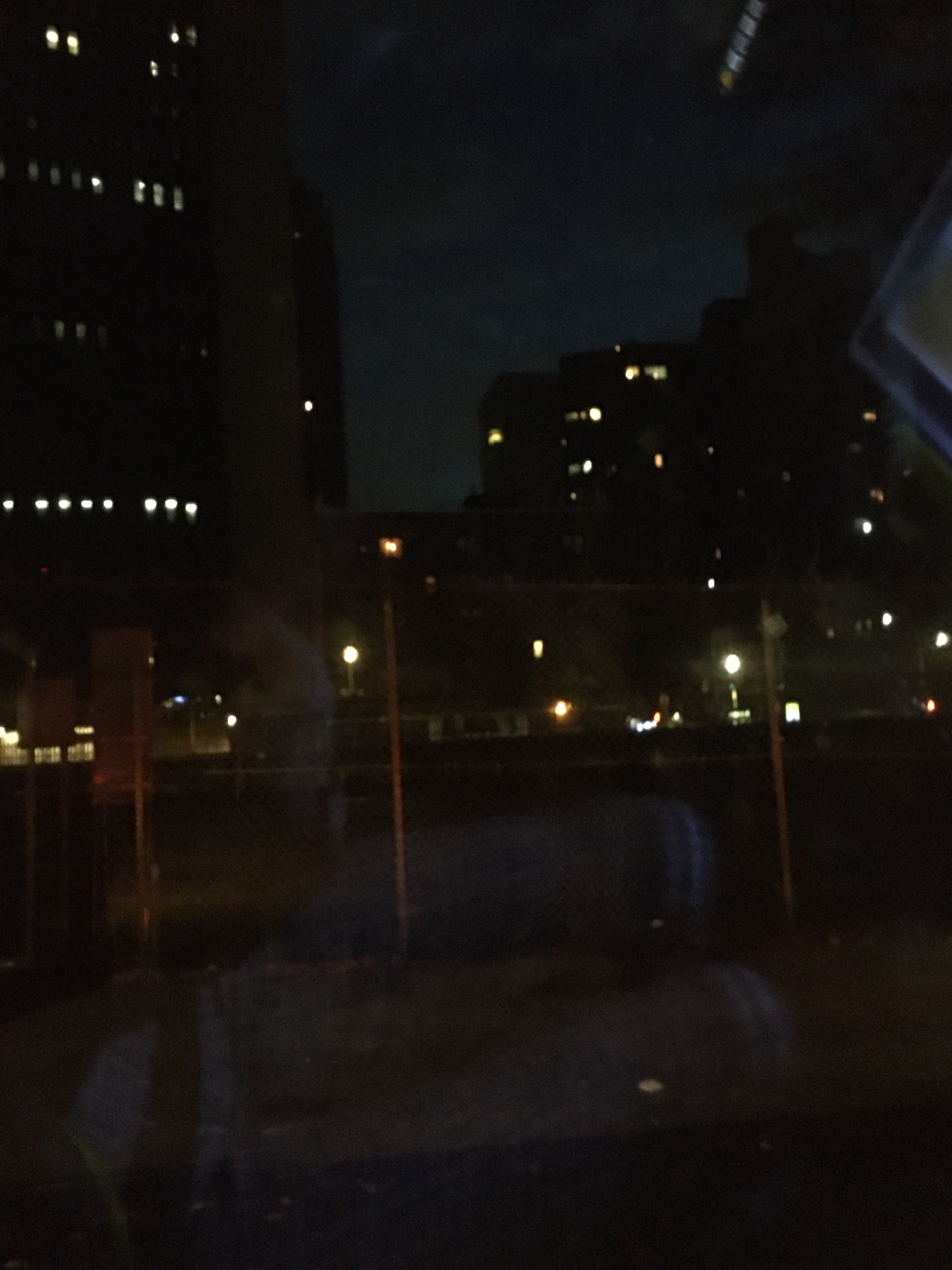 dark buildings with lights twinkling out of windows
