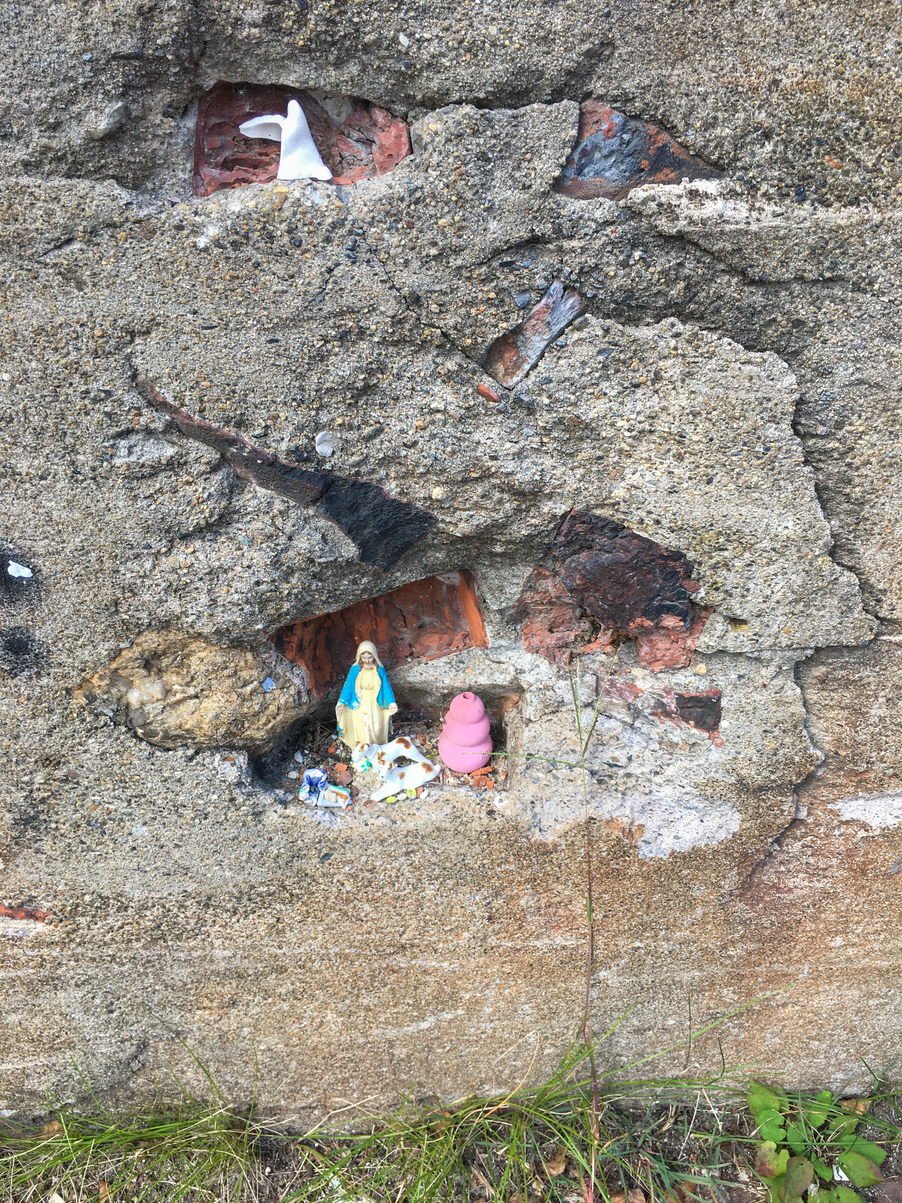dolls in holes in concrete wall