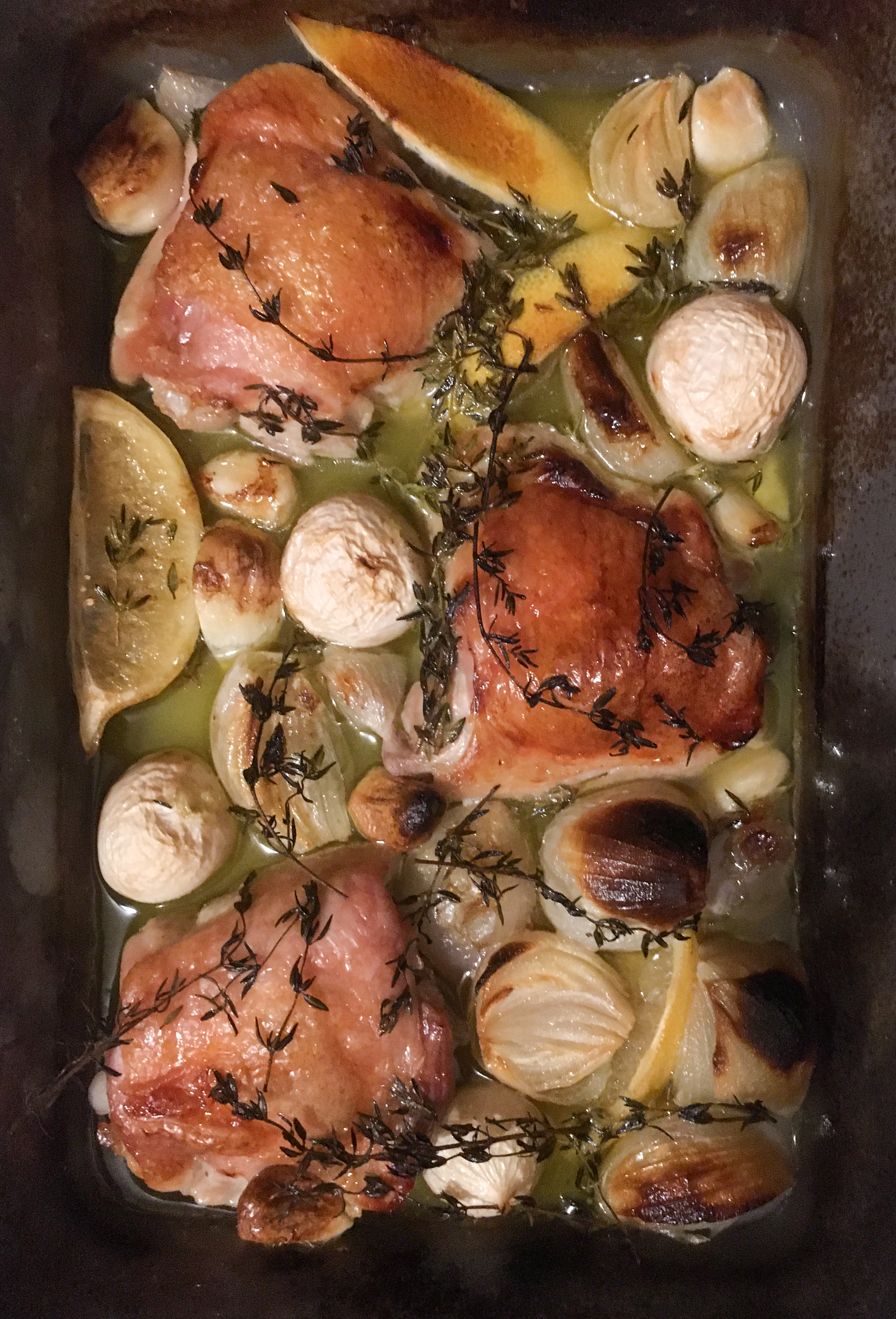 chicken in a pan with lemons