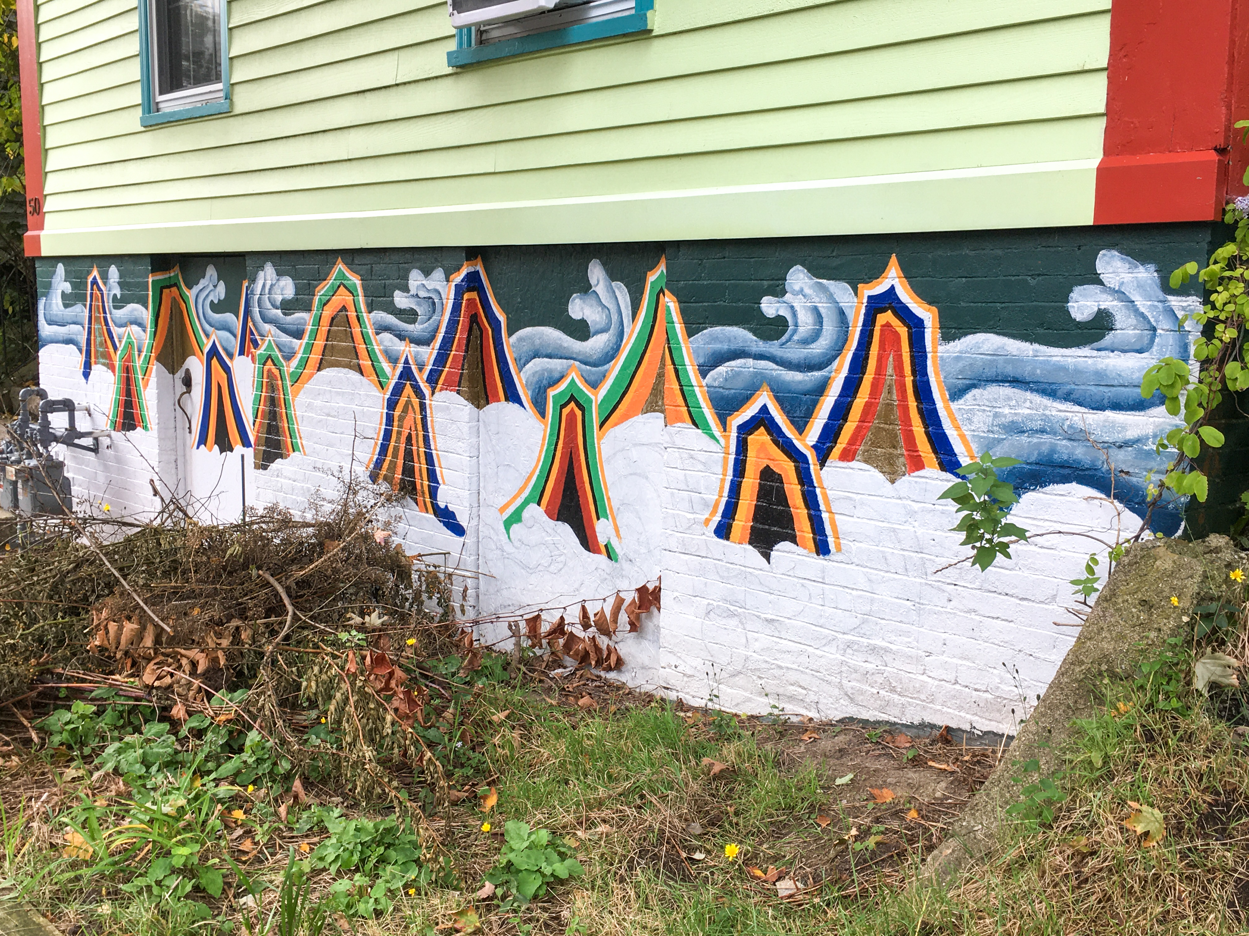 mural of waves or clouds with multi-color mountains with snow