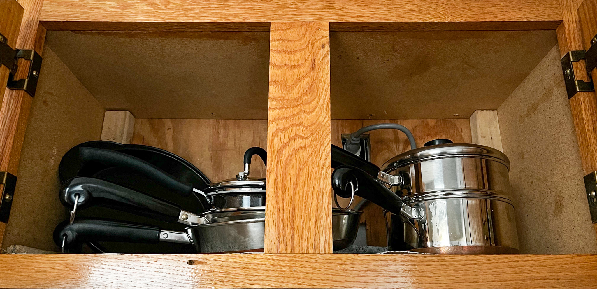 a cupboard of pots and pans