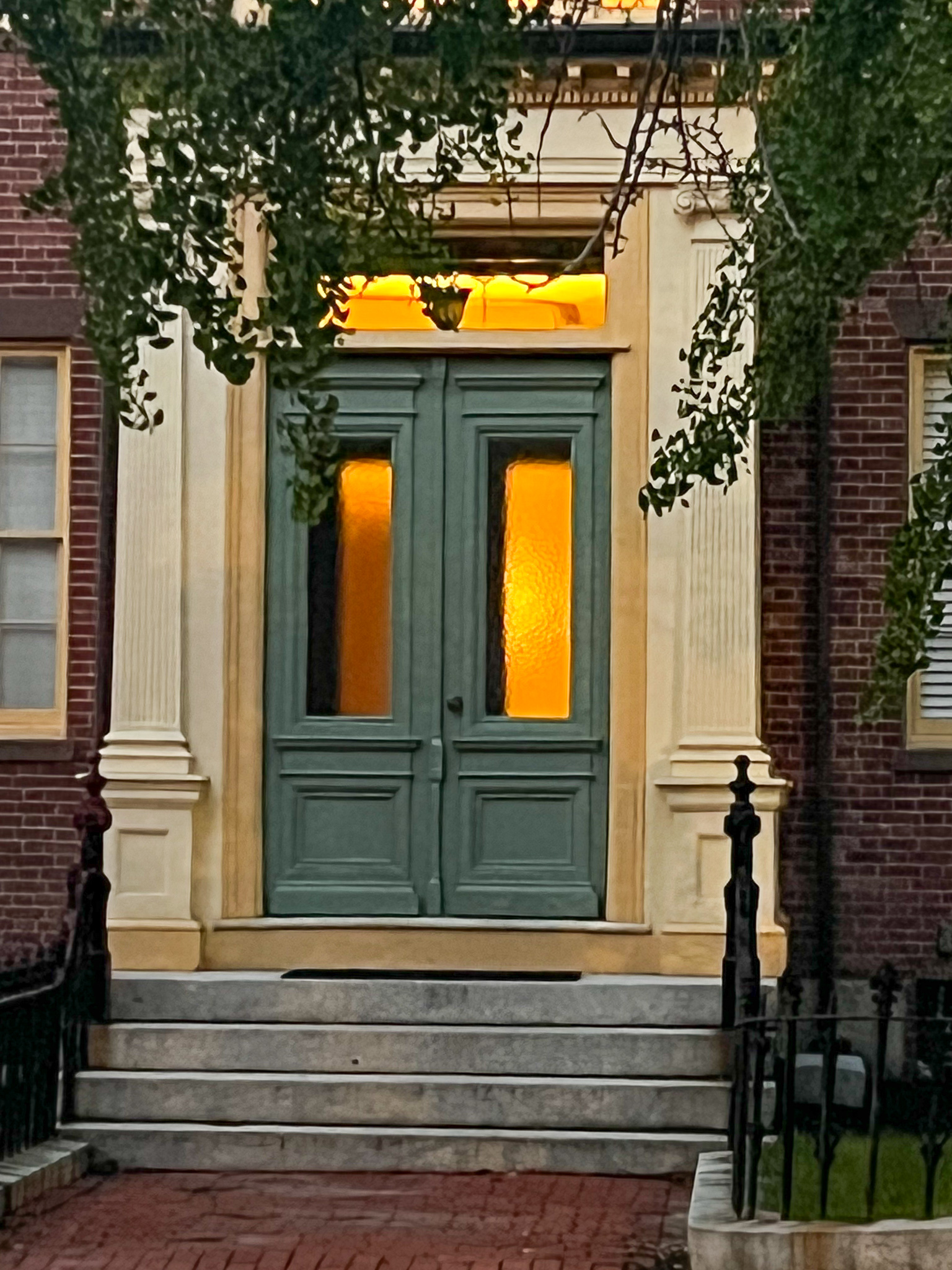 green double doors with golden light
