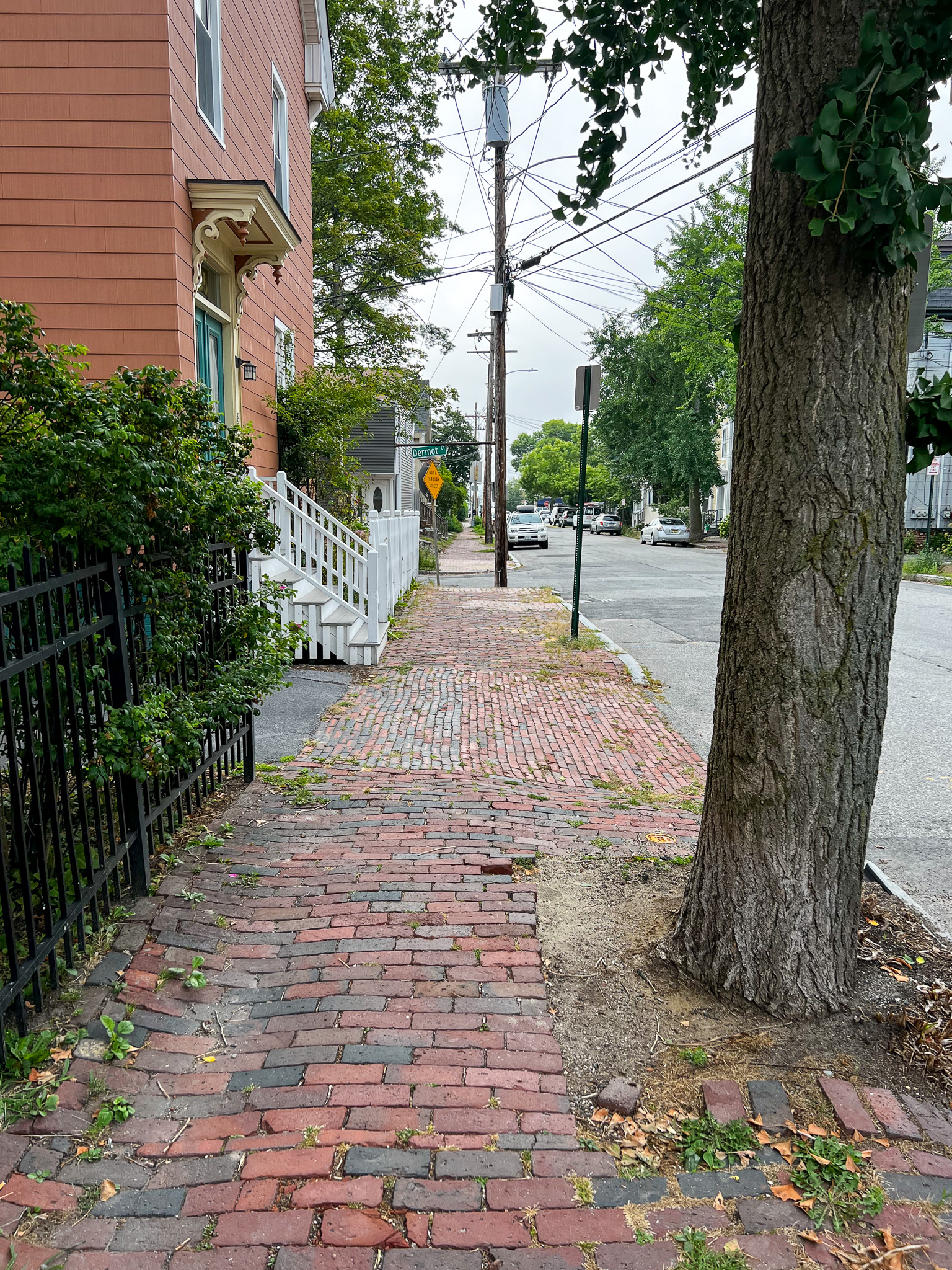 view down a sidewalk with bricks for the sidewalks