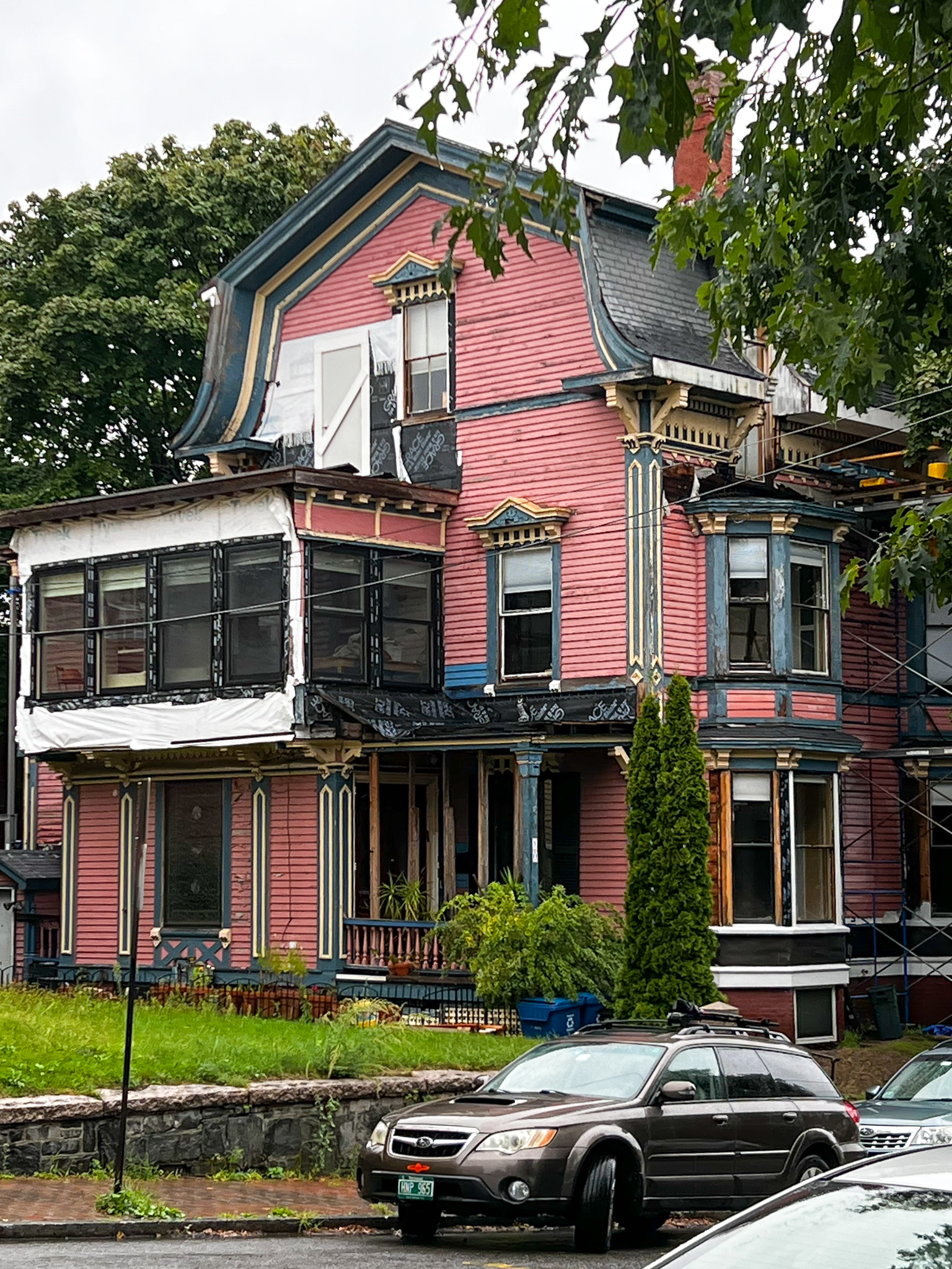 large pink house that needs some work
