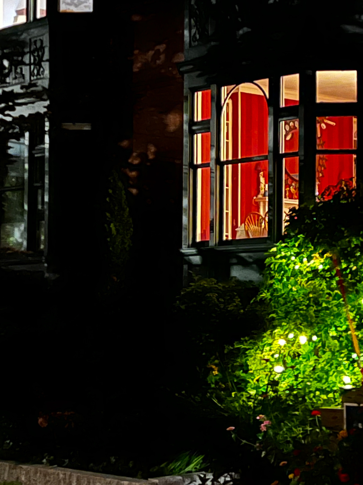 end of the day a night view in a window of a red wall