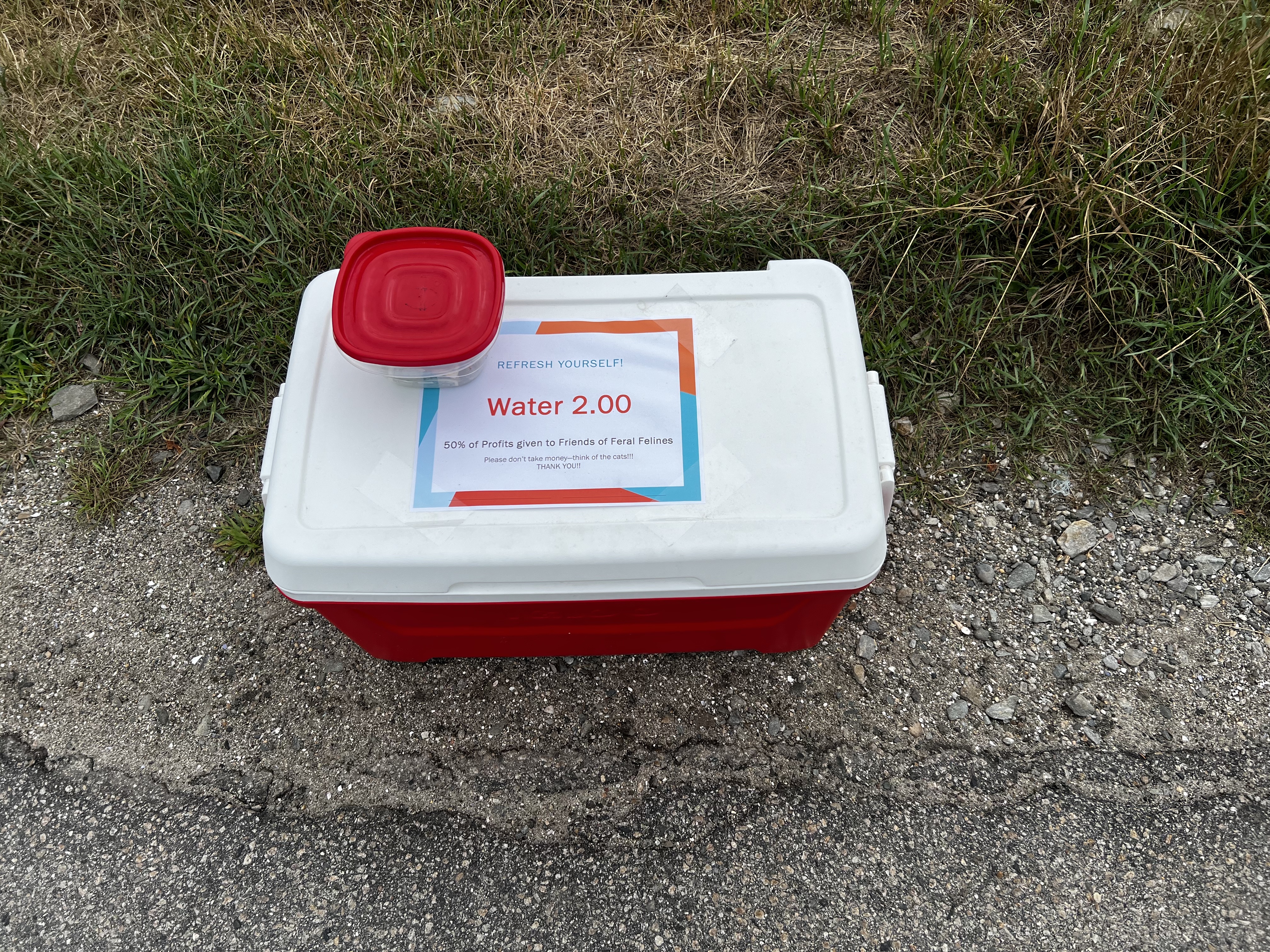 red cooler selling water for 2 dollars