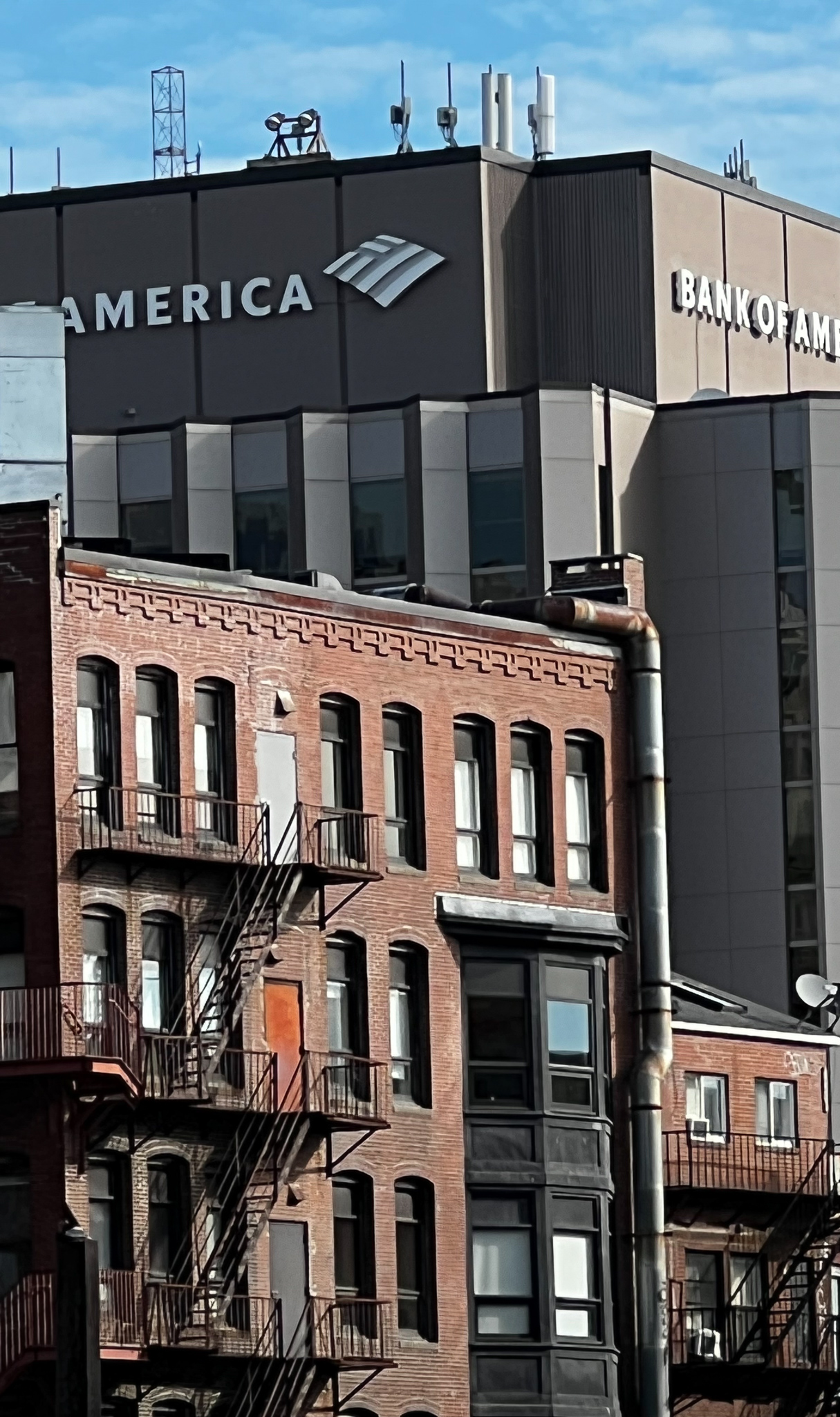 back of an old brick building with fire escapes