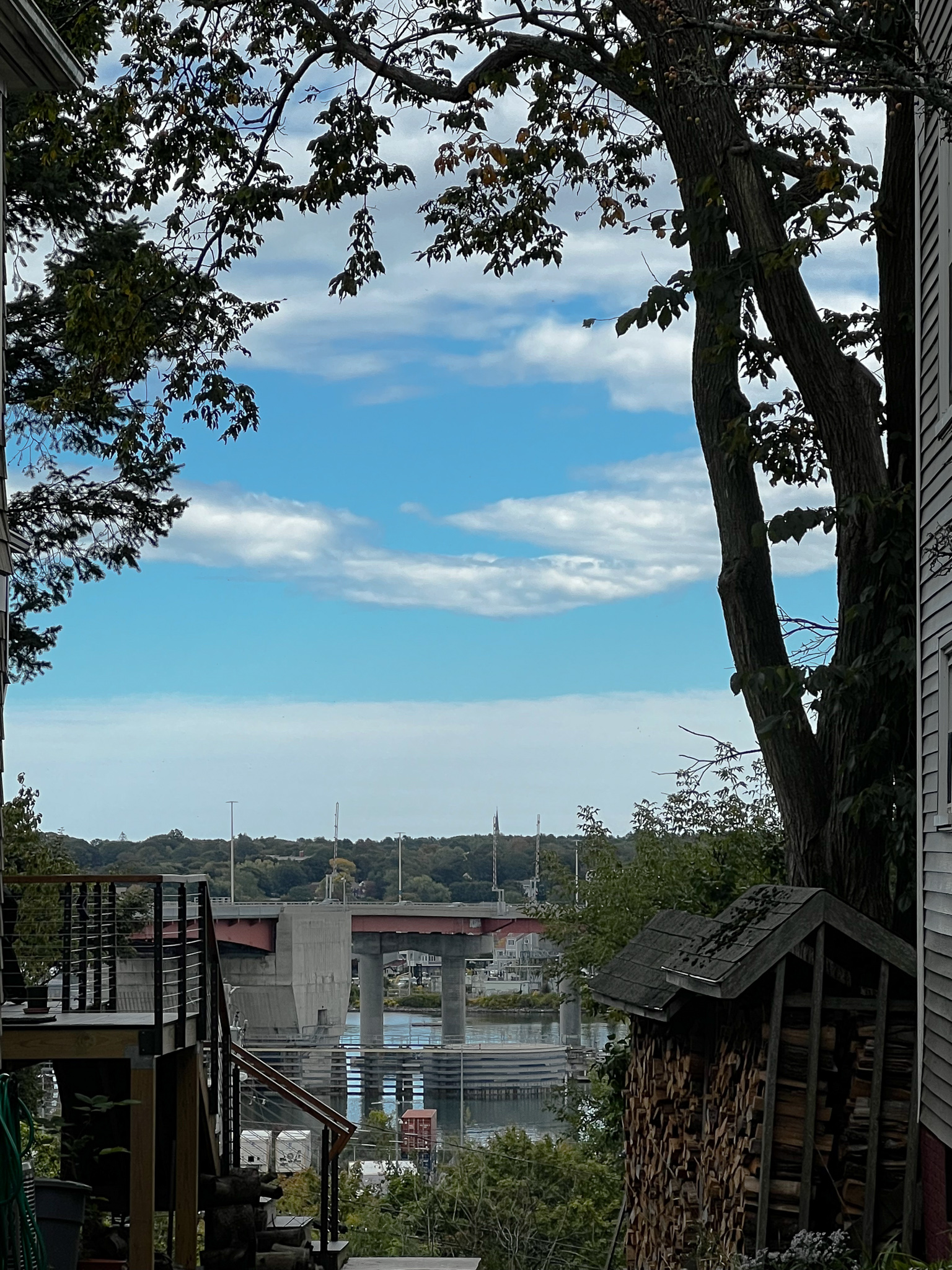 Fore river view between houses and a tree