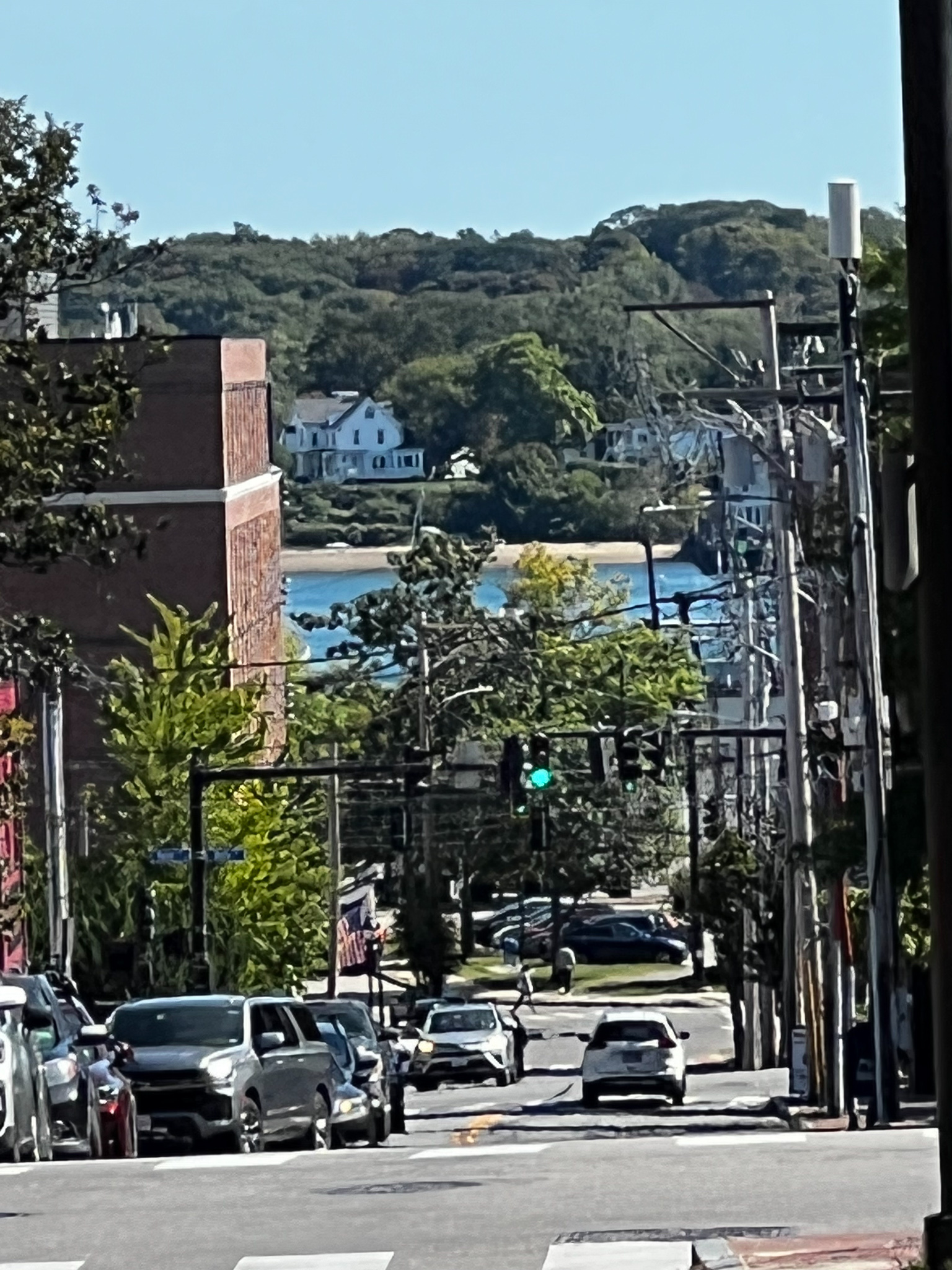 view down Oak Street in Portland Maine between brick buildings you see the blue Fore River