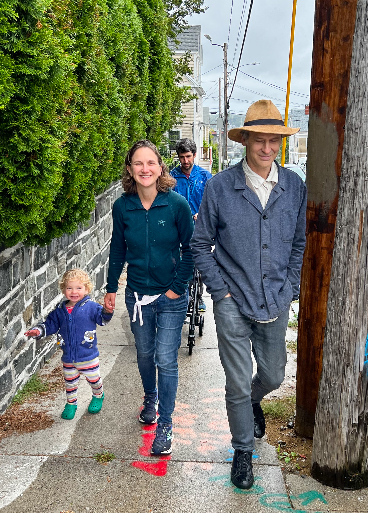 Two men a woman and a child walking