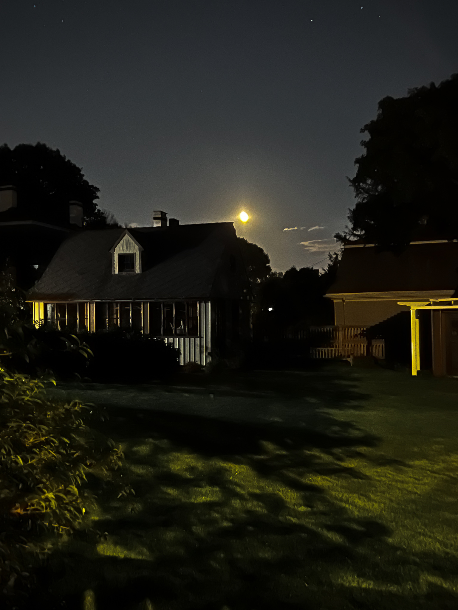 moon coming up over a house in portland maine