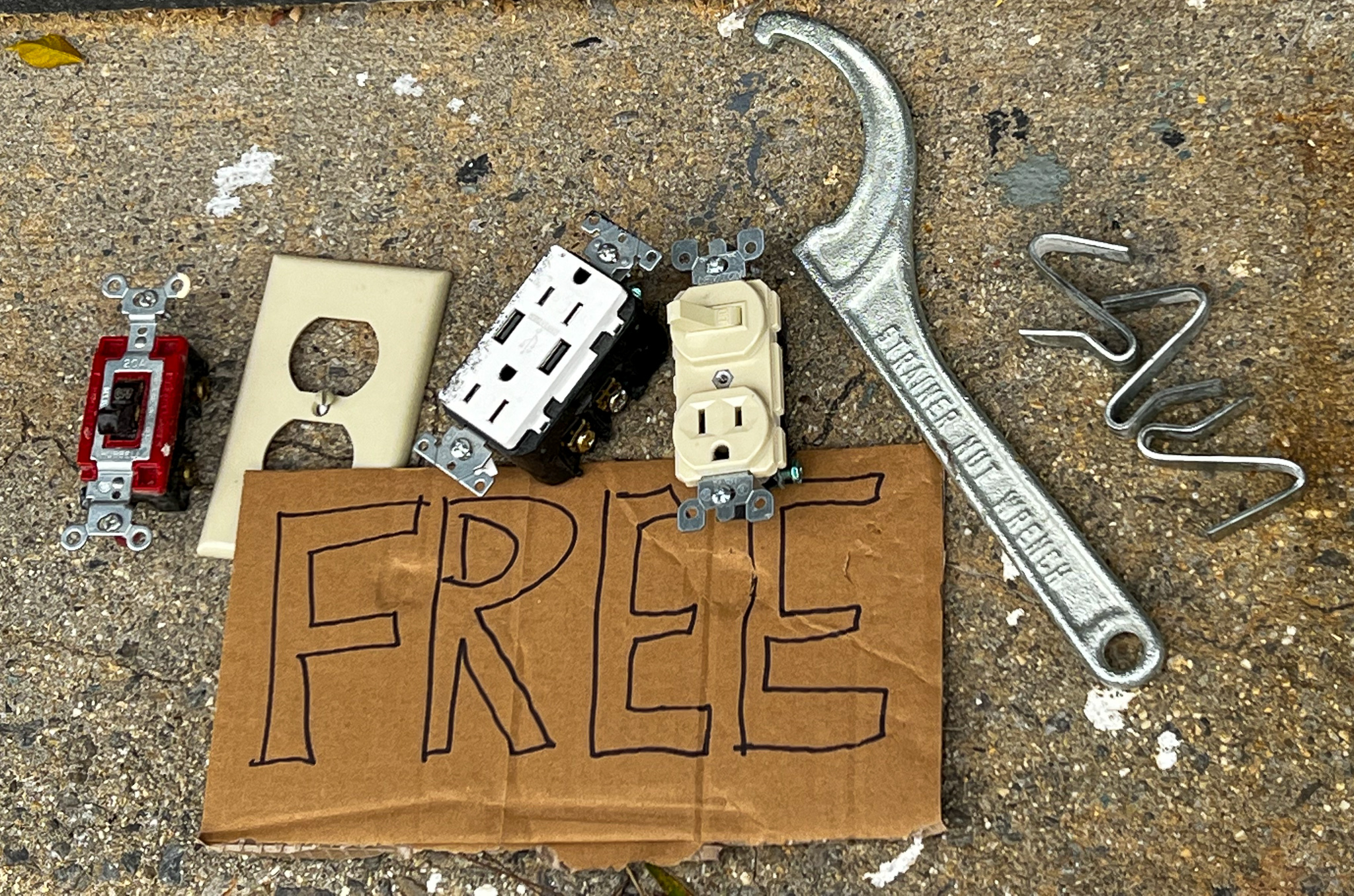 Free sign next to several plugs and other tools and electrician stuff