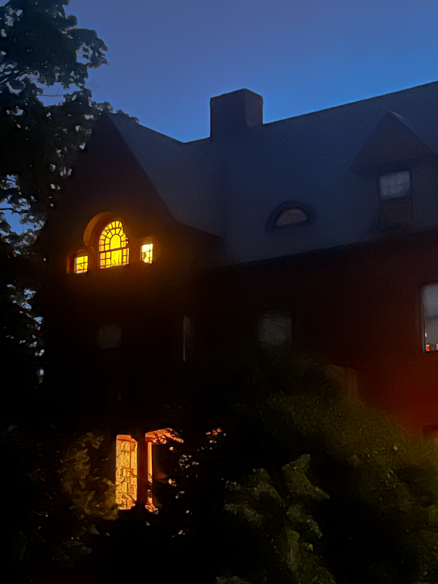 Windows lit up in an old house
