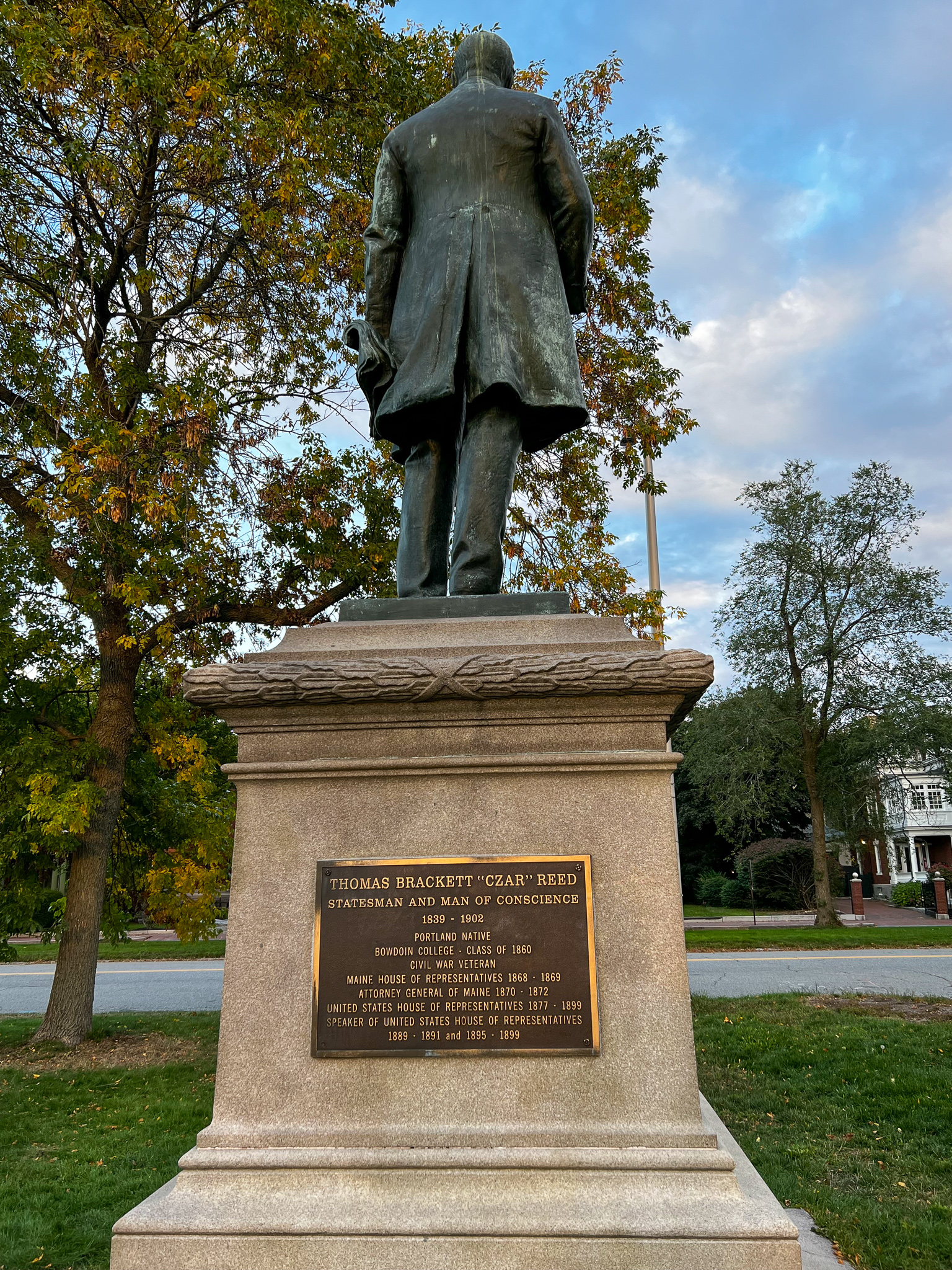 Statue of Thomas Brackett Reed with a plaque outlining his public service. 
