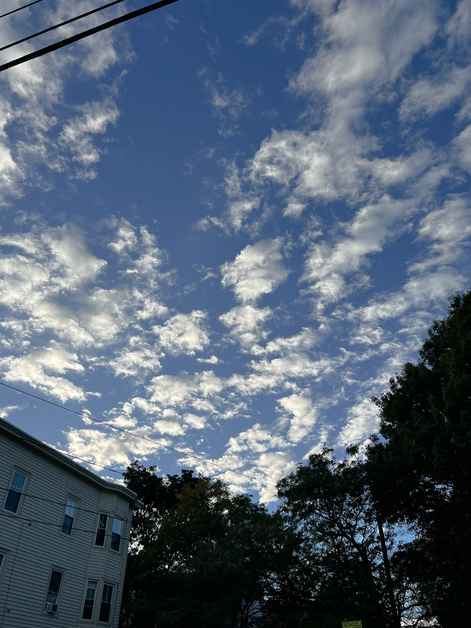 glowing small clouds against a blue sky