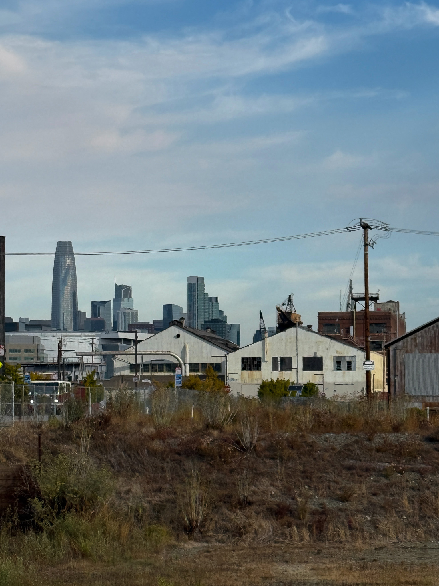old industrial buildings with downtown SF skyscrapers in background